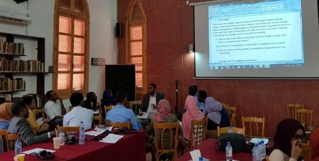 Discussion groups of young people addressing questions on technology and policy to address climate change. Photograph by Nisreen Alsaiem