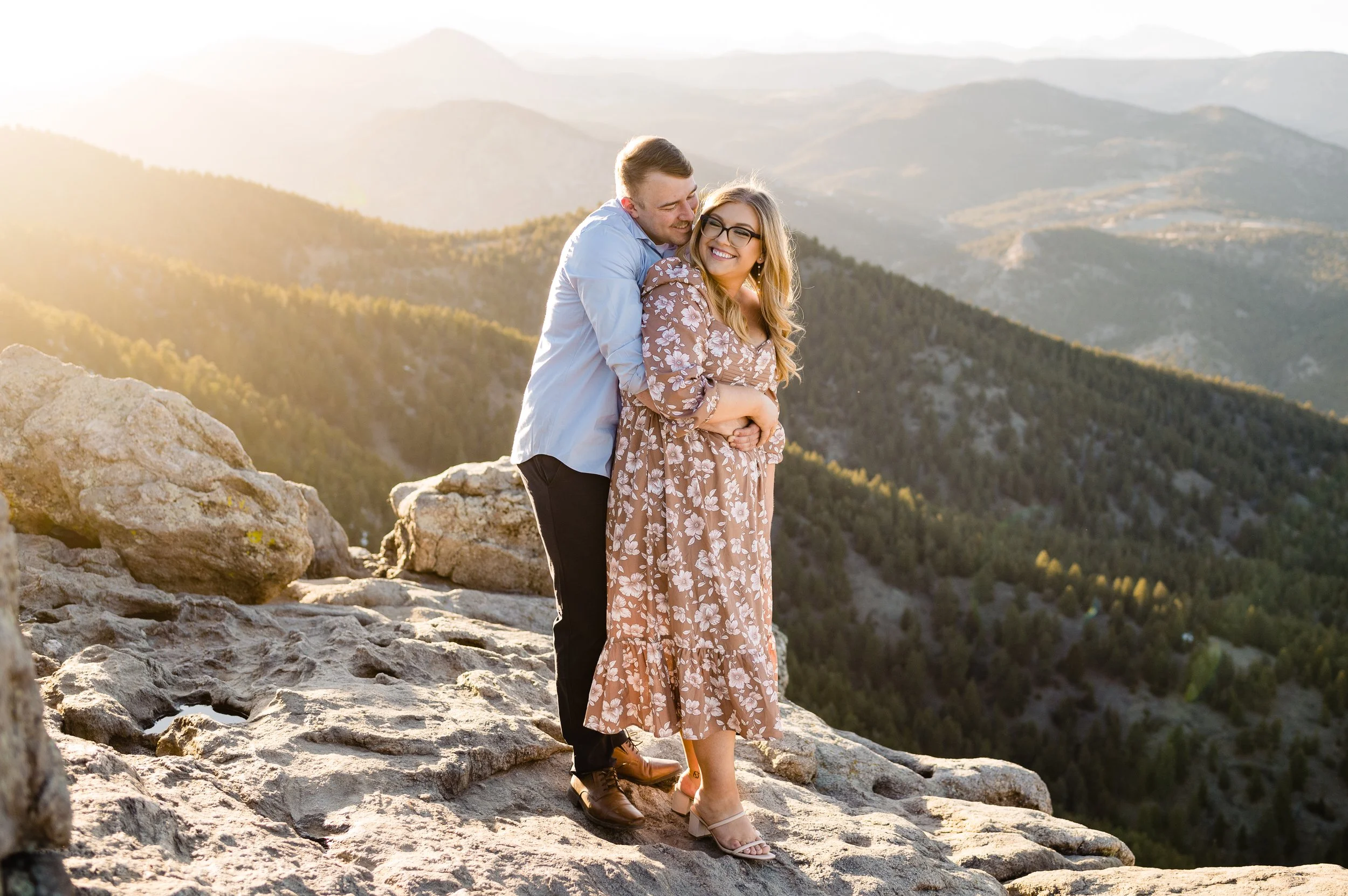Couple hugging from behind at Lost Gulch Overlook with their dogs