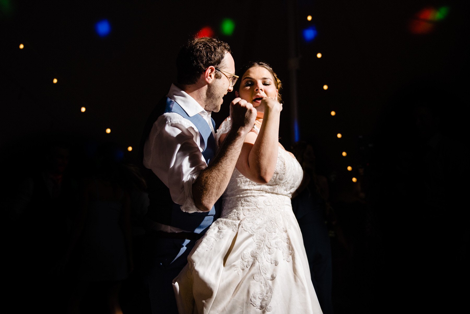 a bride and a groom dance on the dance floor at their wedding reception