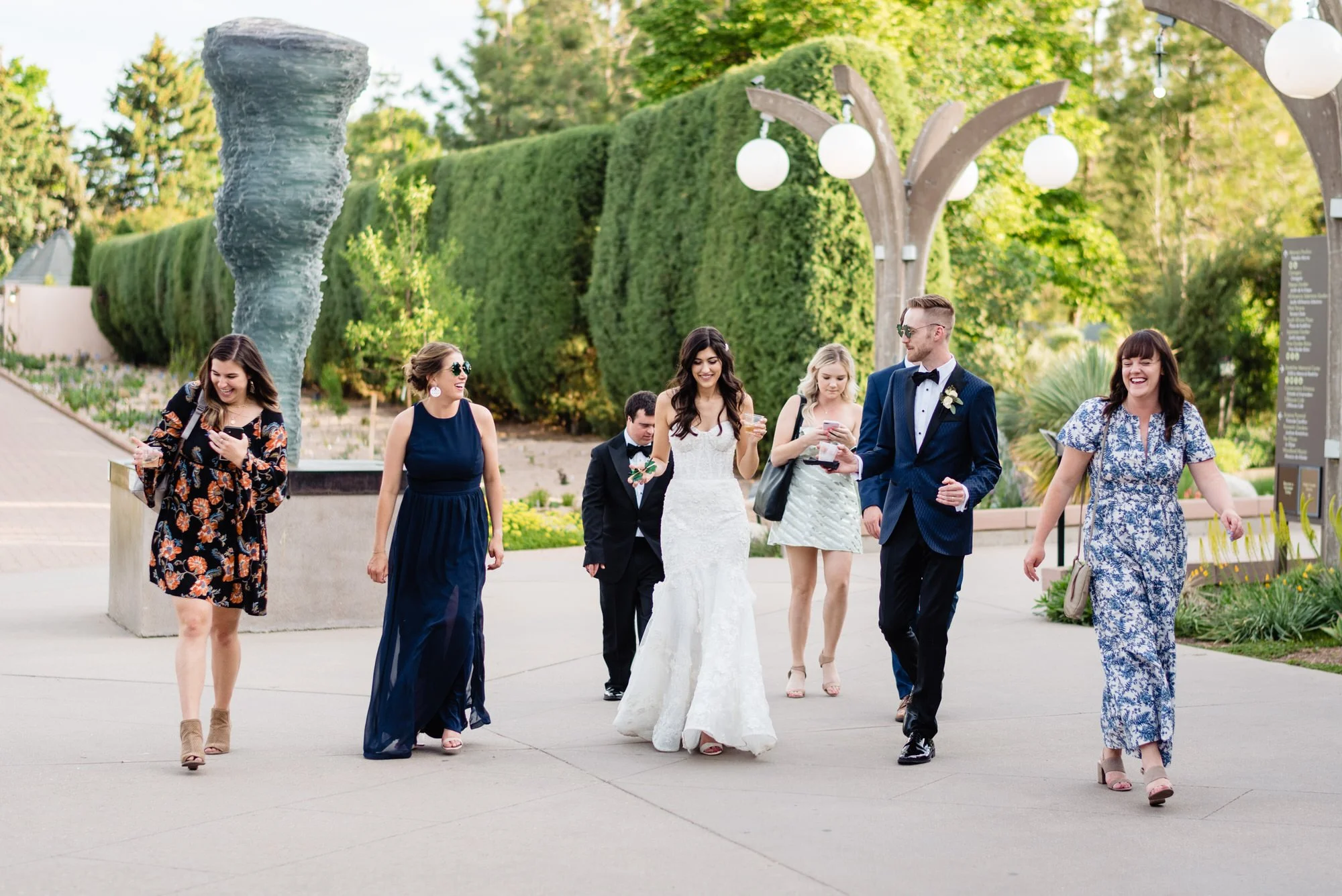 Bride and wedding guests walking through Denver Botanic Gardens after the ceremony