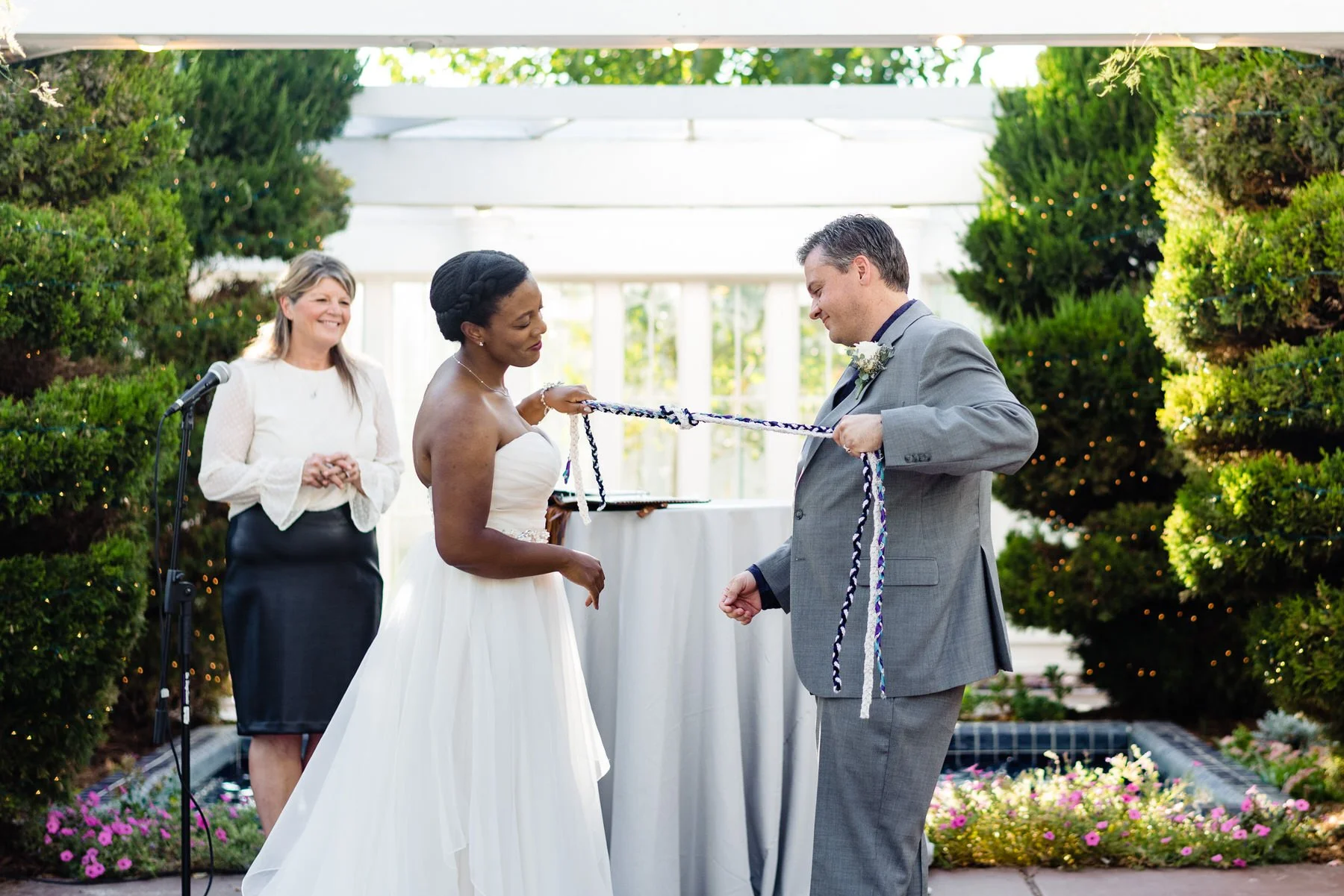 bride and groom tie a knot at their wedding ceremony