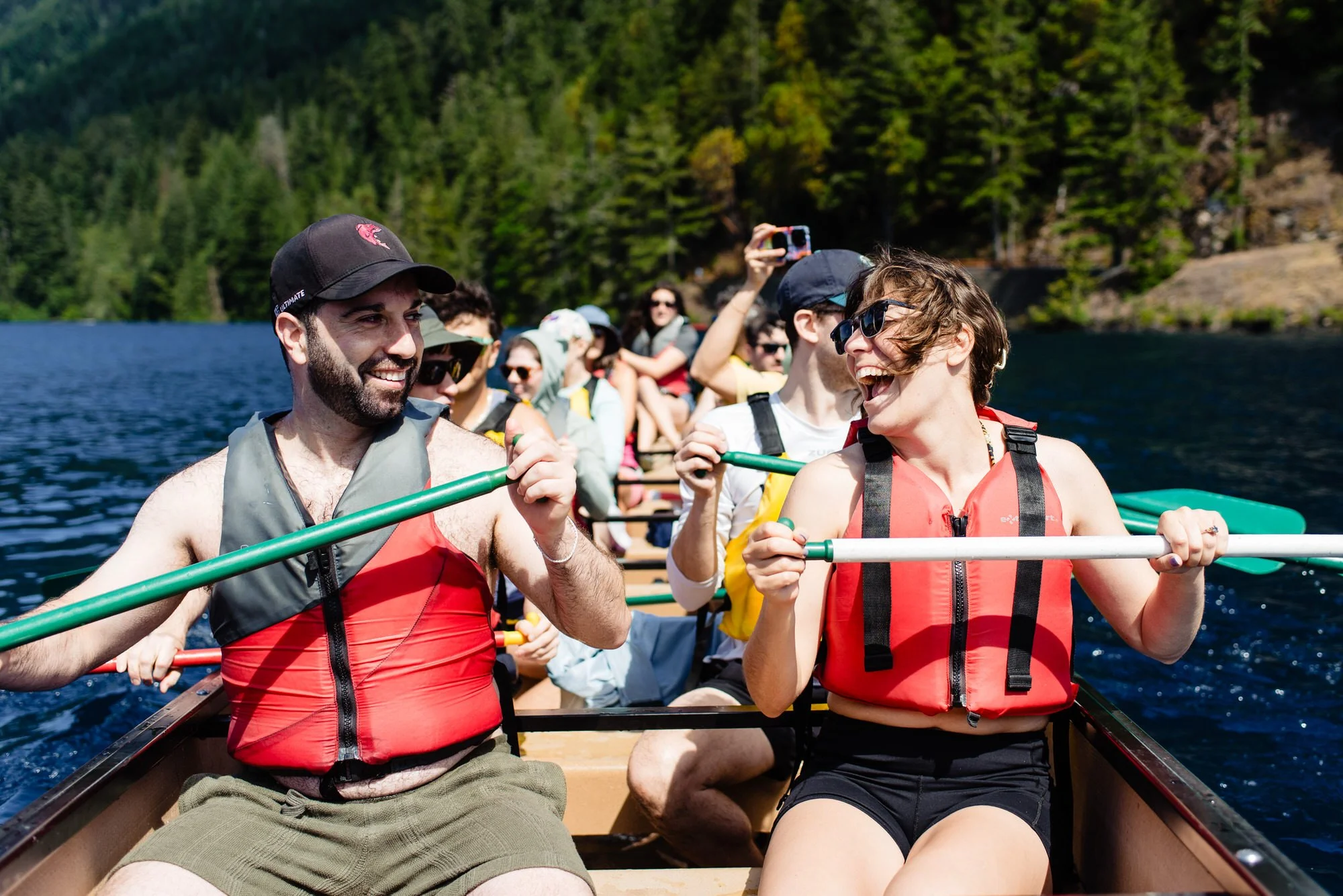 a bride and groom take a canoe ride the morning of their wedding
