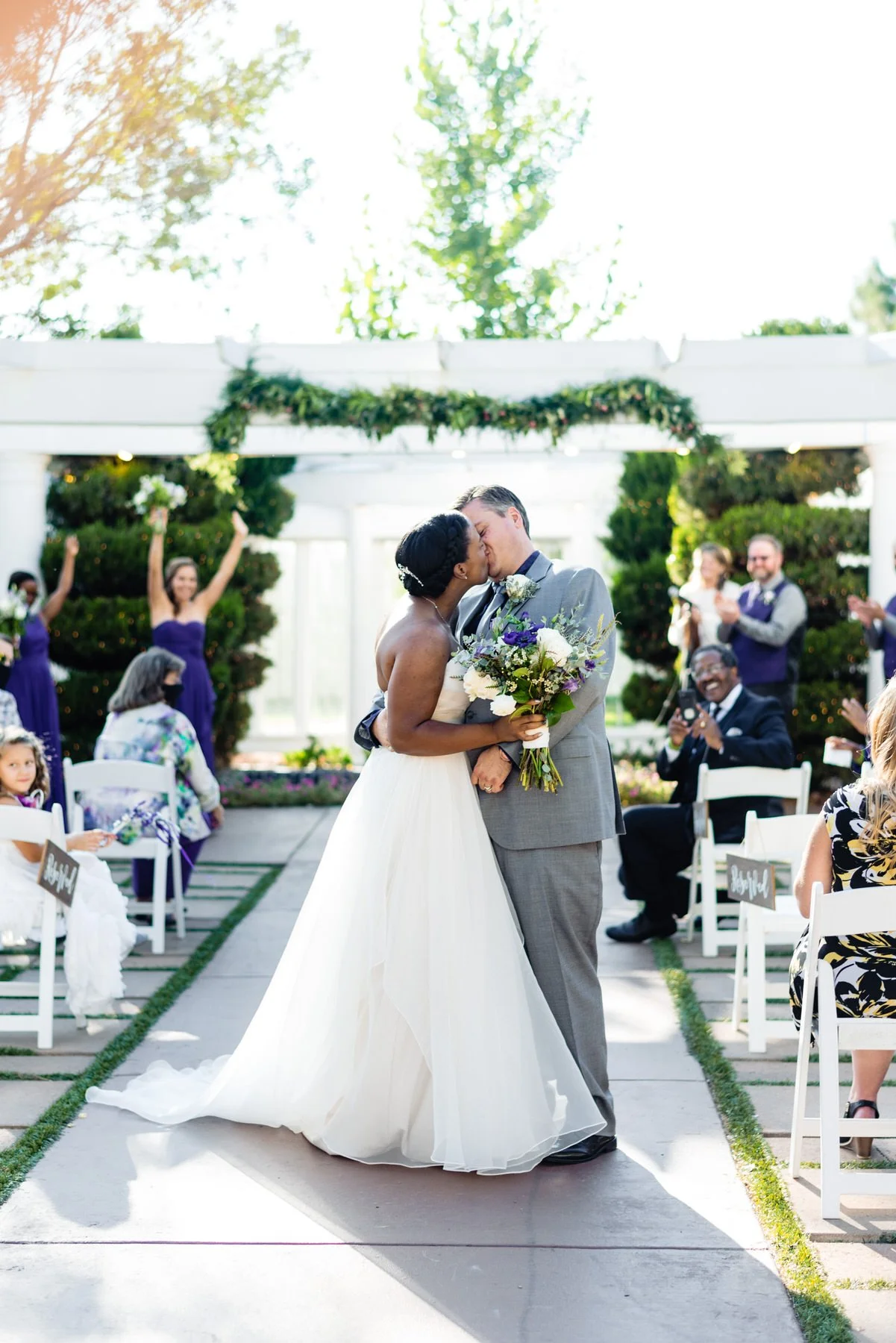 Bride and Groom share a kiss after their wedding ceremony at Lionsgate Event Center