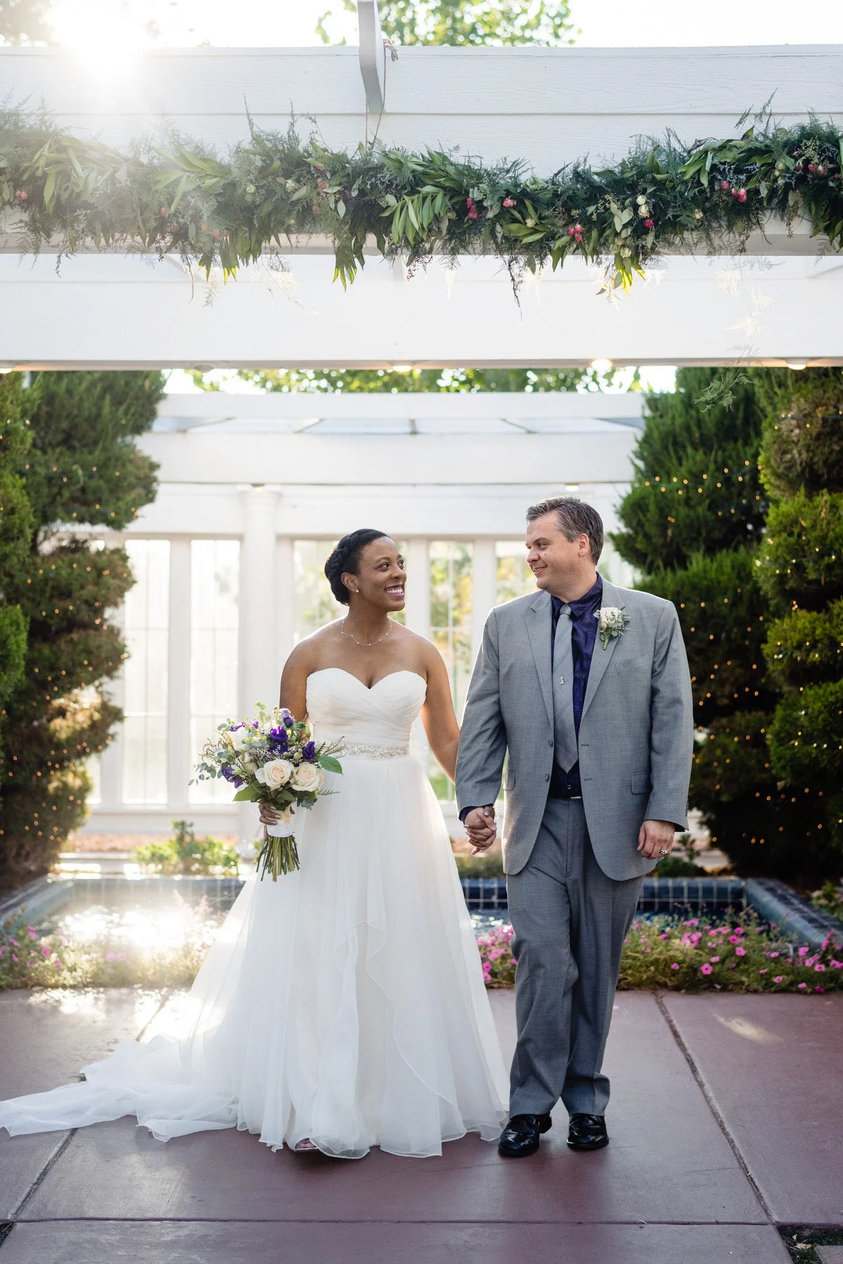a bride and groom walk together for their portraits at their Lionsgate Event Center wedding