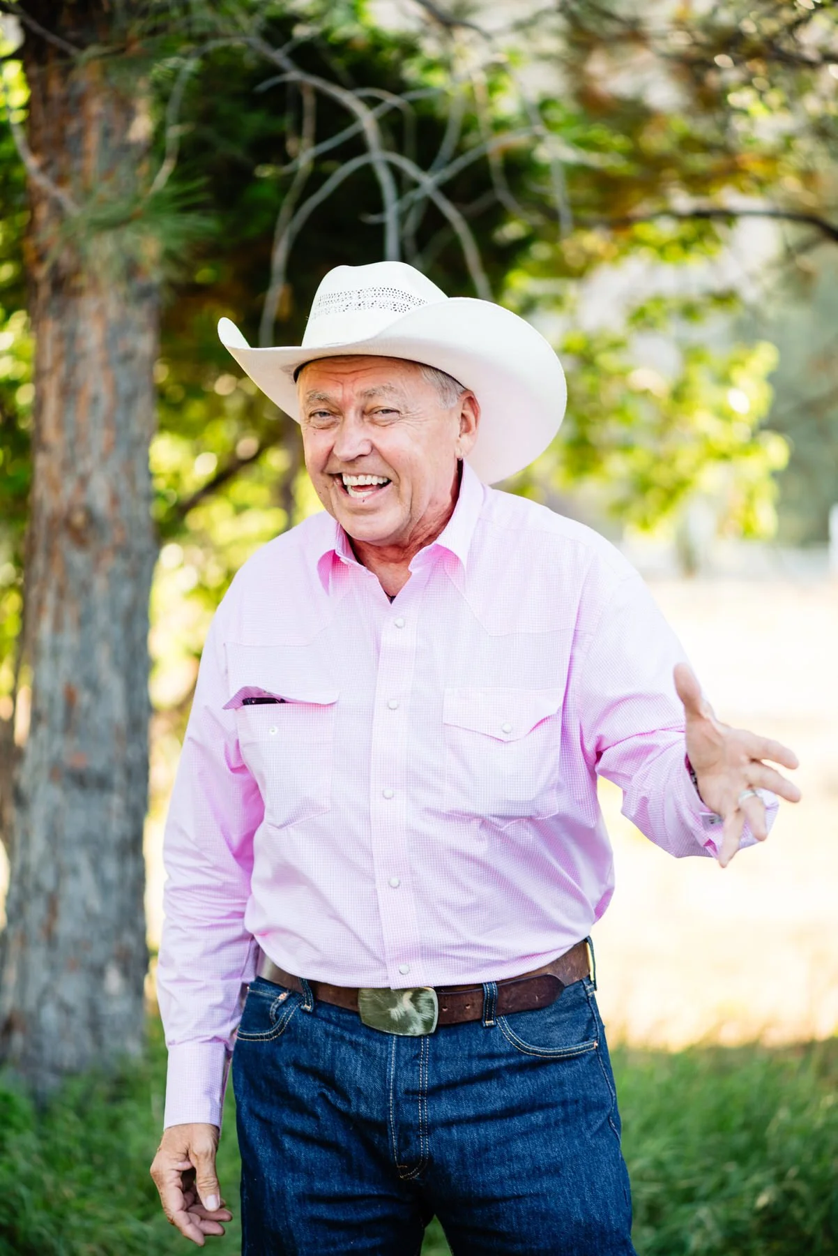 a man in a cowboy hat gives a speech during a wedding