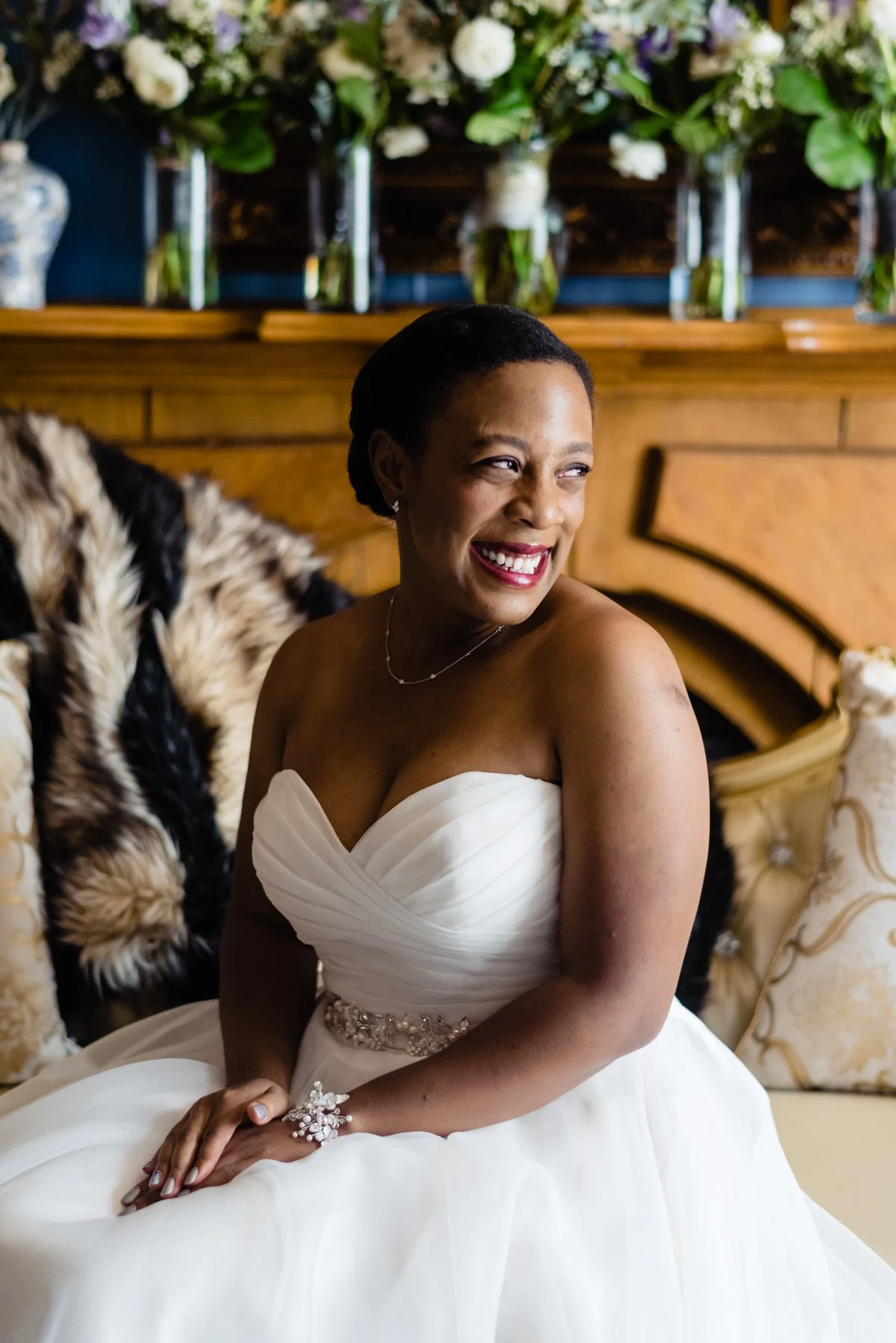 bride looks out the window after getting ready in the Gatehouse at Lionsgate Event Center