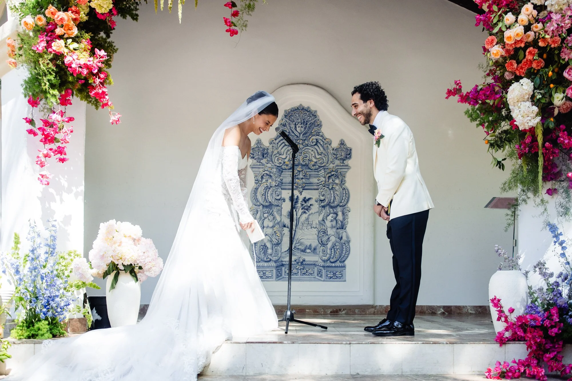 bride and groom share a laugh during their wedding ceremony