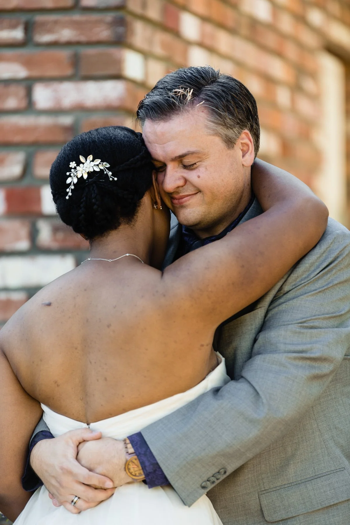 bride and groom share a hug after their first look