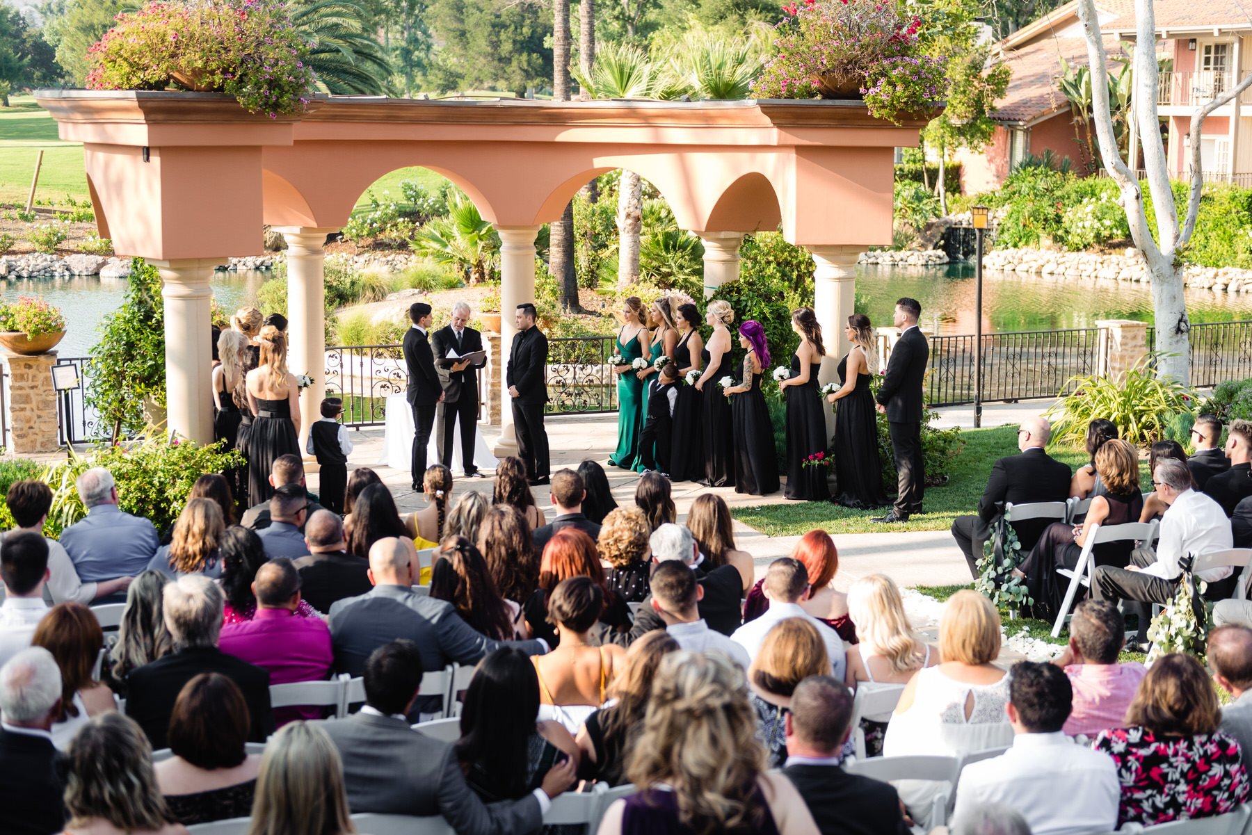 two grooms get married sourrounded by loved ones during their wedding ceremony