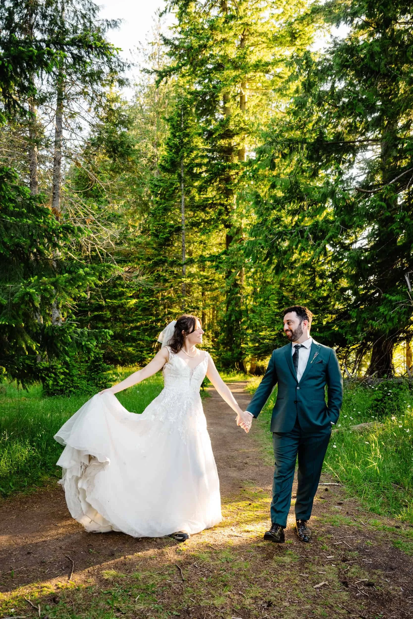 man and woman walk through the woods during their wedding