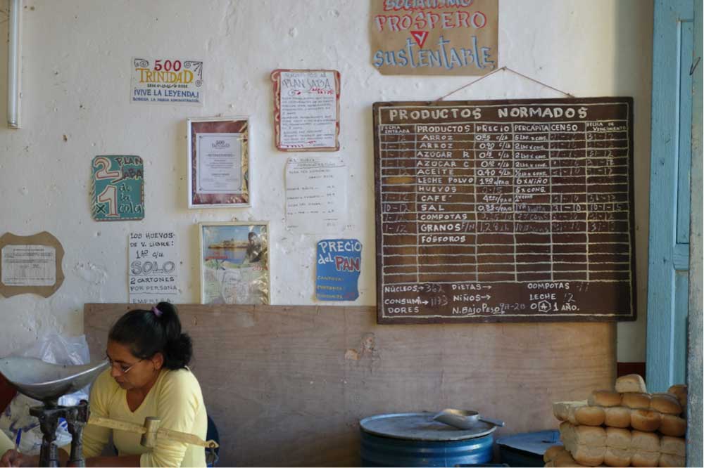 Government run grocery store with posted ration amounts and prices.