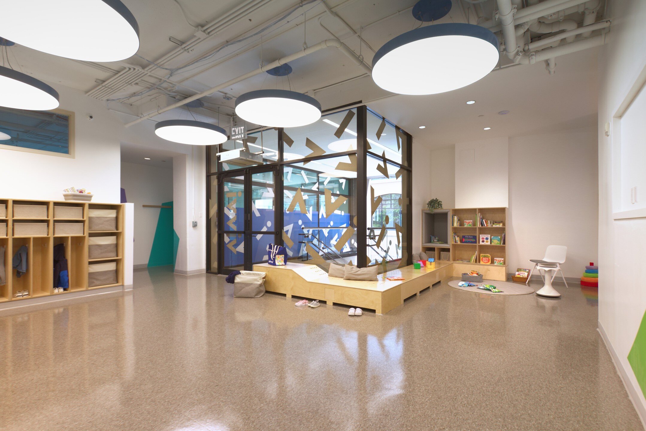 Special Spaces at School. This lobby is brought to life by our design for a bench, radiator cover, and shelves to create a mini-library space within the entry area. Custom &ldquo;confetti&rdquo; window film and colorful accents invite the children to