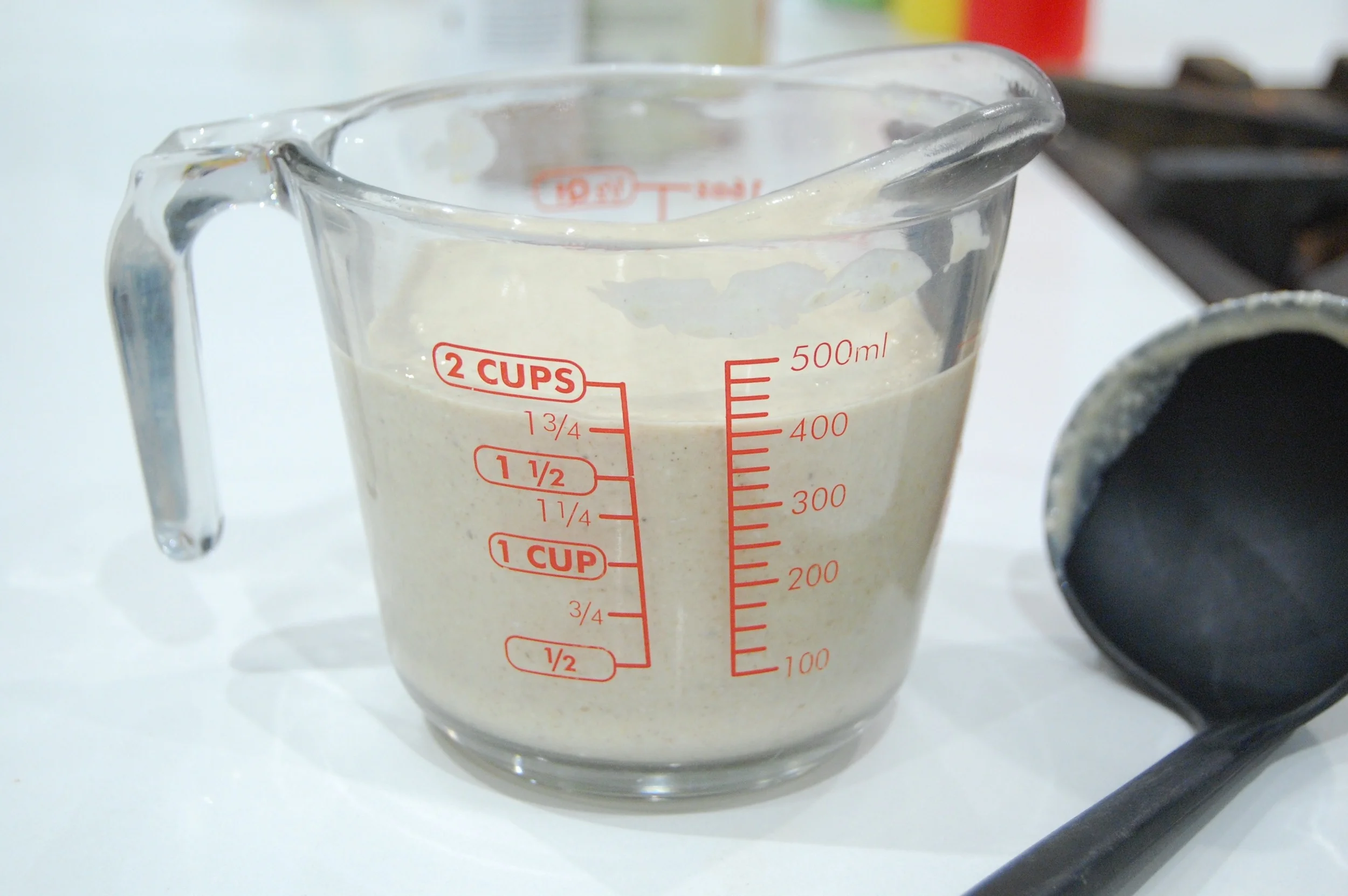 I pour my batter into a measuring cup so it's easier for me to get my ladle in there to spoon out uniform amounts onto the griddle. 