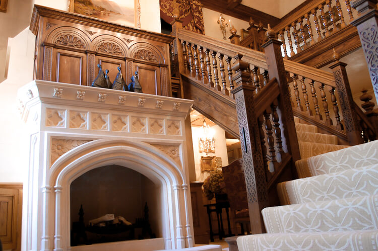 16th, 17th century style oak staircase and hall with hand carved fireplace overmantel