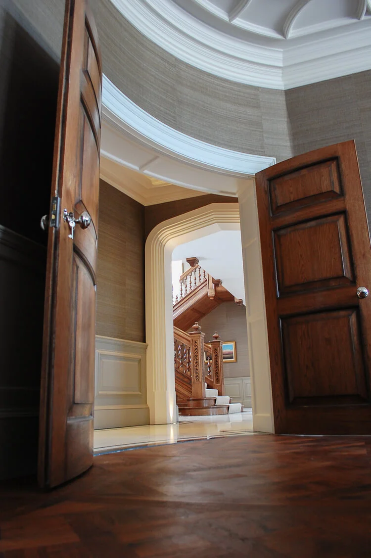 a set of impressive curved double doors opening omn to the large stair hall.jpg