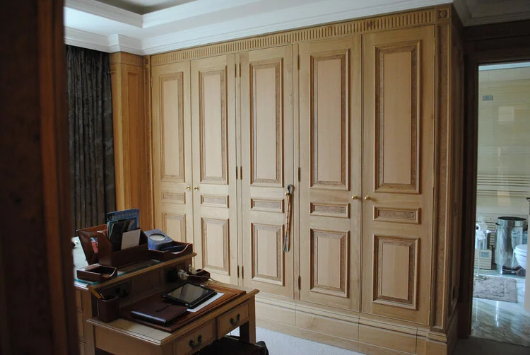 Dressing room with panelled wardrobes featuring walnut burr fielding.jpg