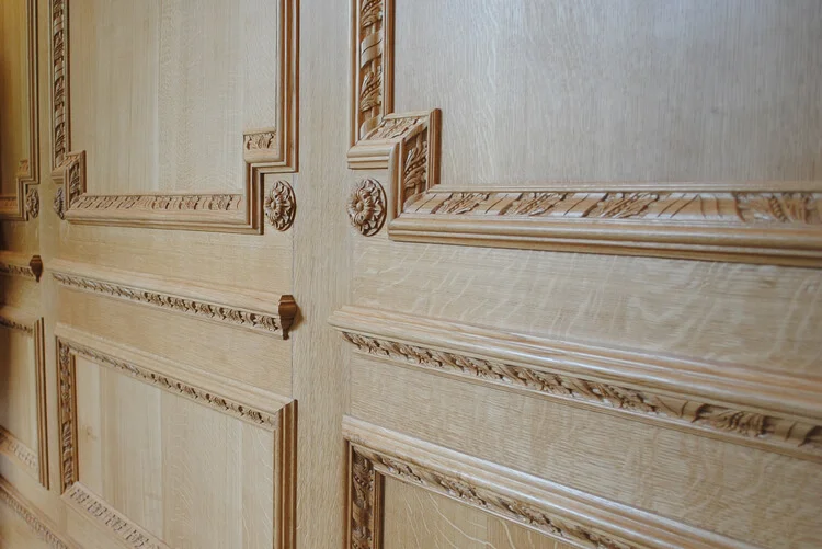 Large panels in this panelled study with bespoke carving decoration finished in a light oak.jpg