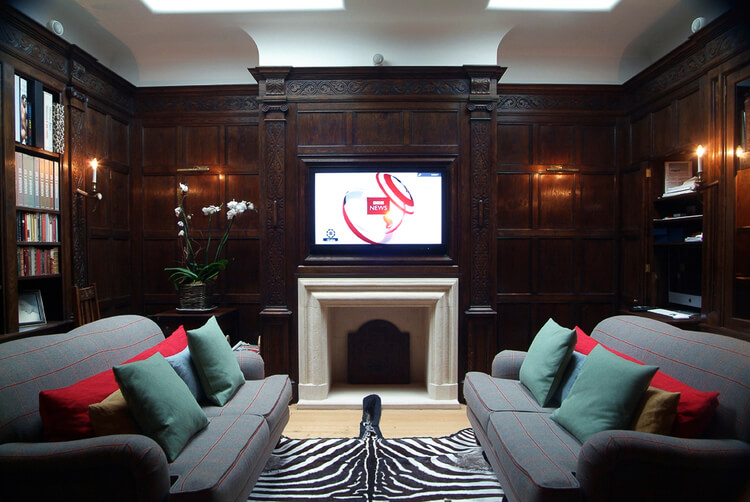 Oak panelled library with hidden television screen and computer.jpg