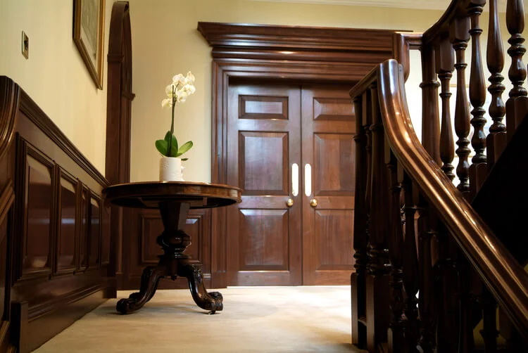 18th century style stairhall with Georgian style panelling and swept staircase handrail with turnings.jpg