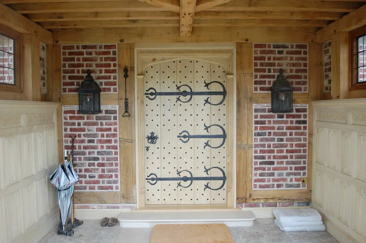 Porch joinery external oak panelling and large Gothic door.jpg
