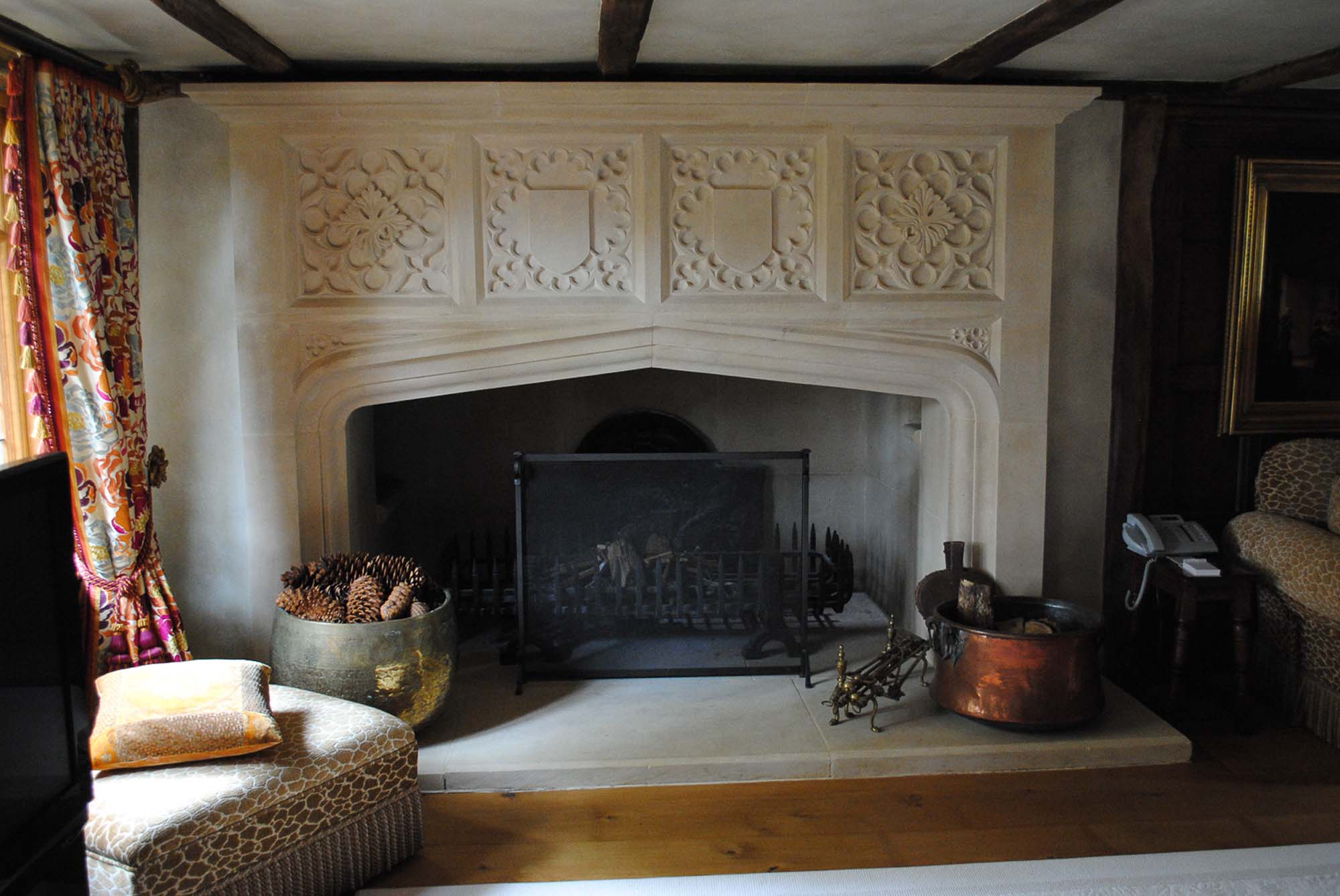 Portland stone fireplace with hand carved Gothic style quatrefoils and shields