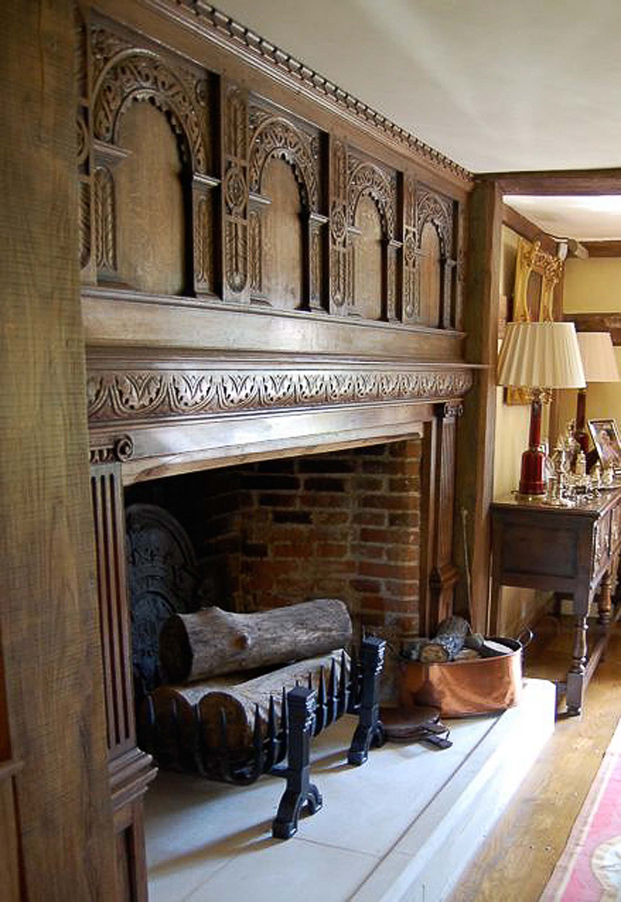 16th and 17th century style oak panlled fireplace with highley decorative carved arches