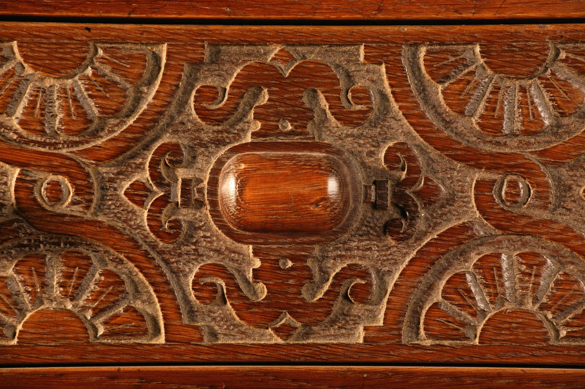Carved drawer front with Jacobean style strapwork made in solid oak