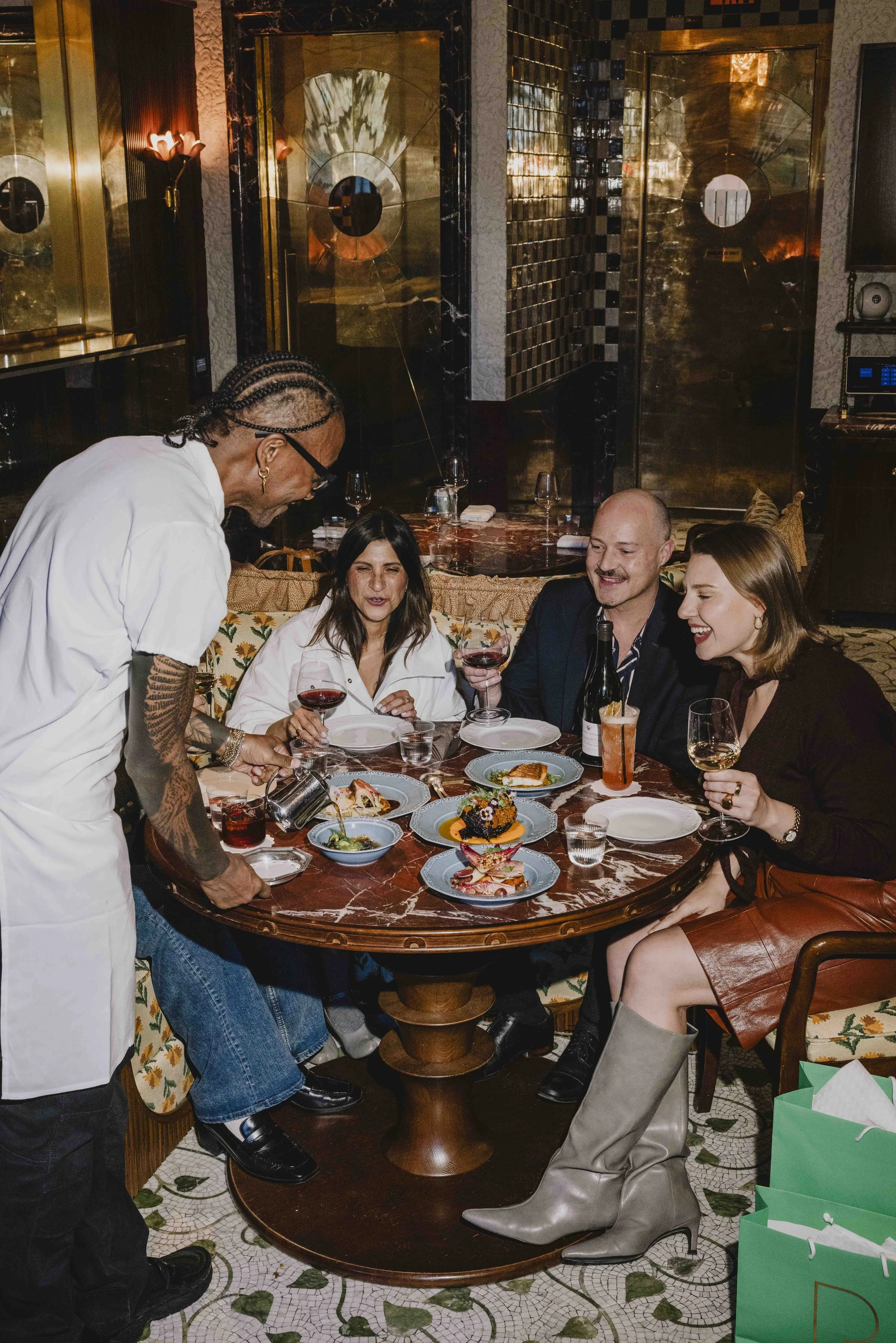chef-pouring-sauce-to-group-tableside.jpg