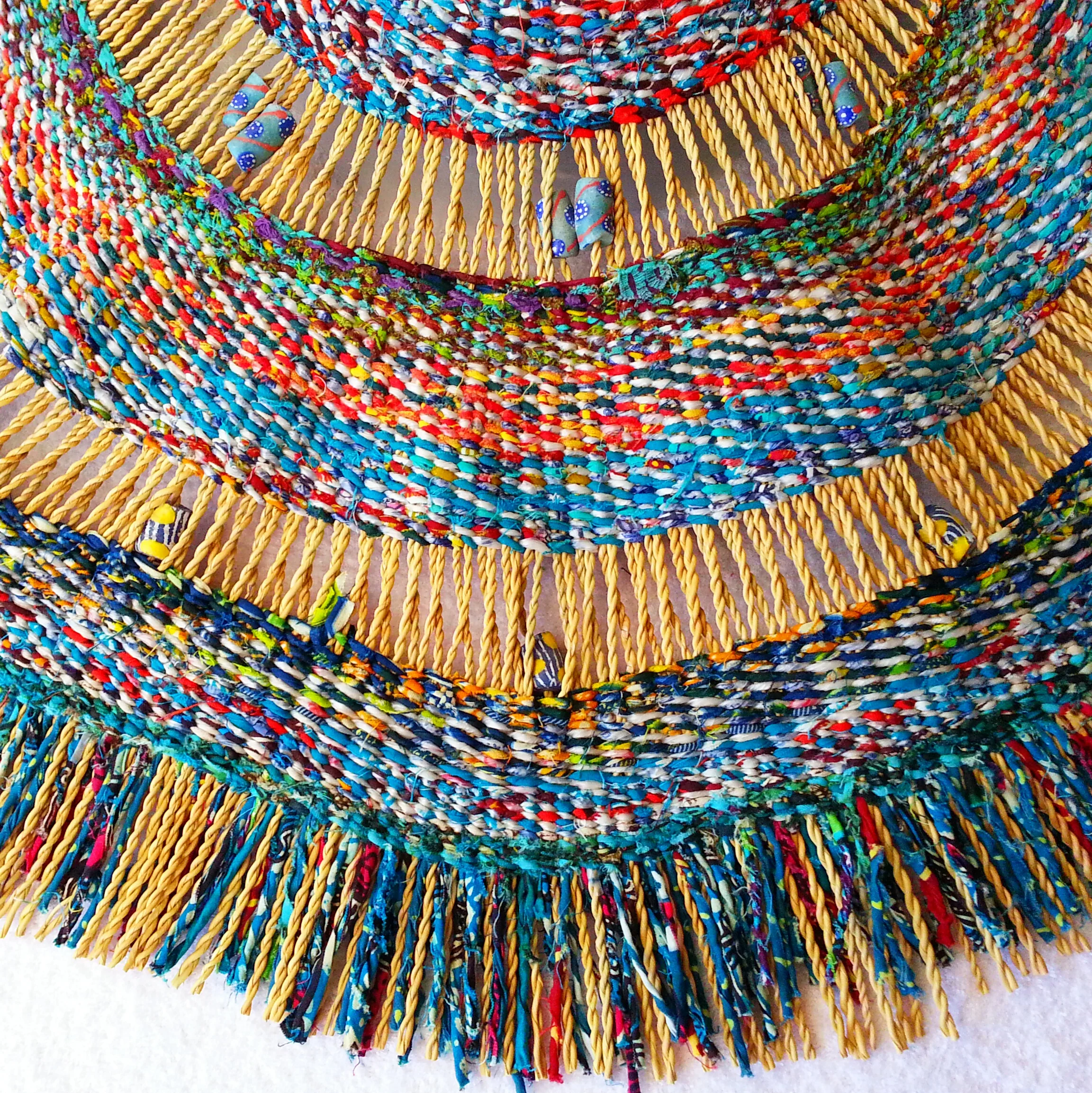 Detail of weaving with recycled plastic, cloth and beads.jpg