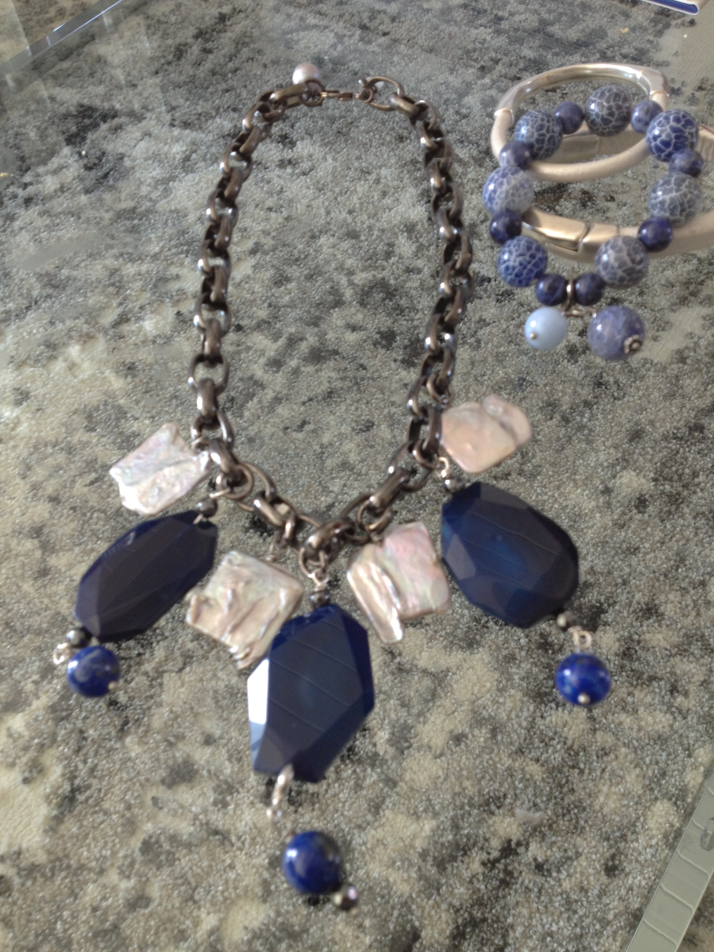 Lapis, agate and pearl necklace on heavy chain Cracked blue ceramic, white jade with rhinestone bracelet Leather and silver bracelets