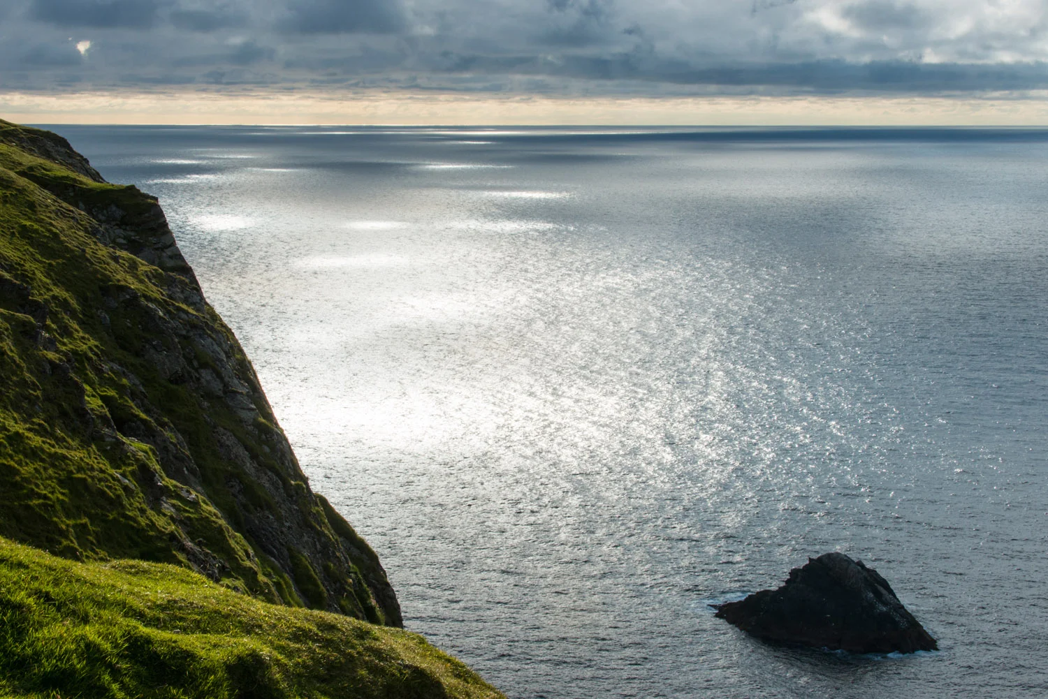 Western coastline and sunlight dappling North Atlantic Ocean, Hermaness National Nature Reserve, Unst, Shetland Islands, Scotland