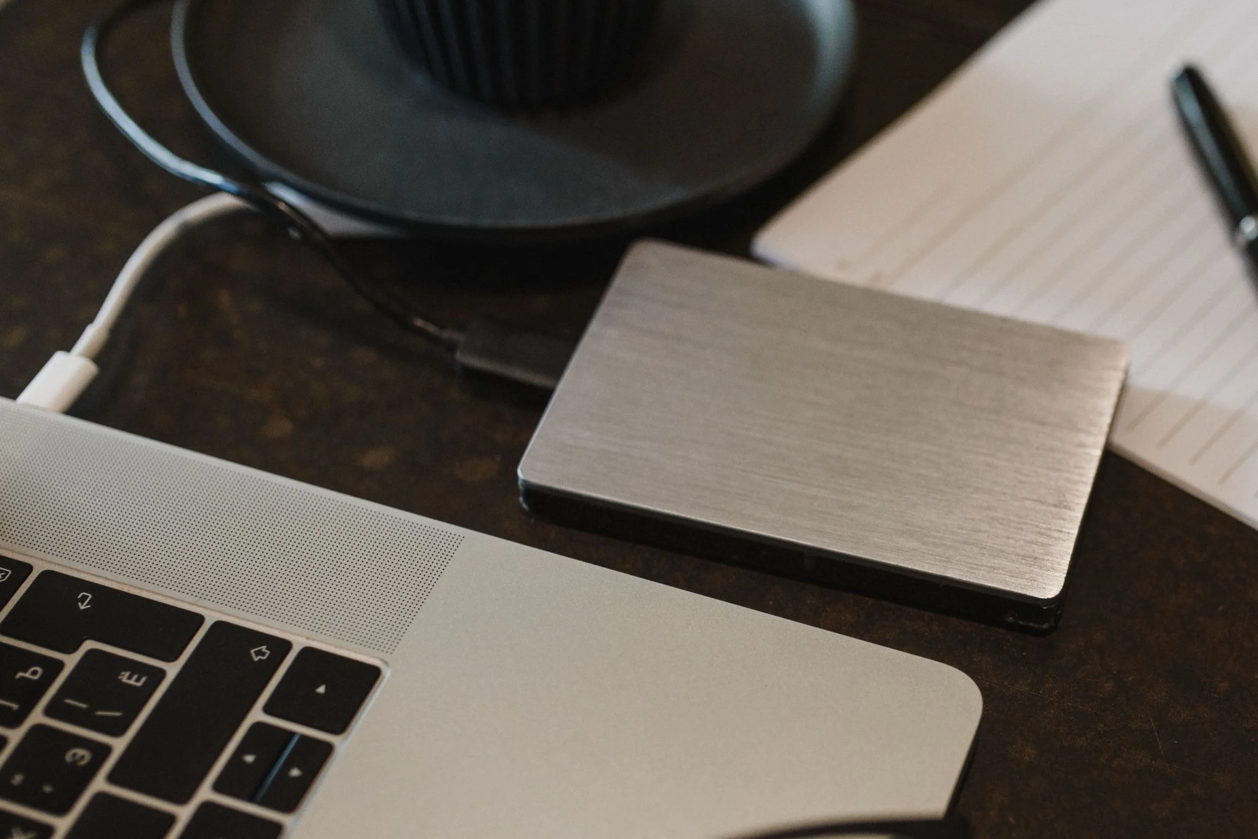 Portable hard drive beside laptop