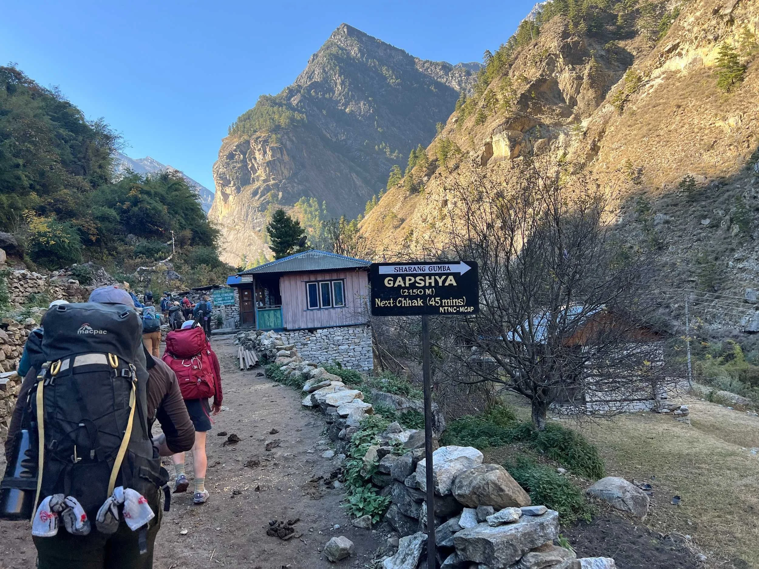Hikers approaching a hut in the Himalayas