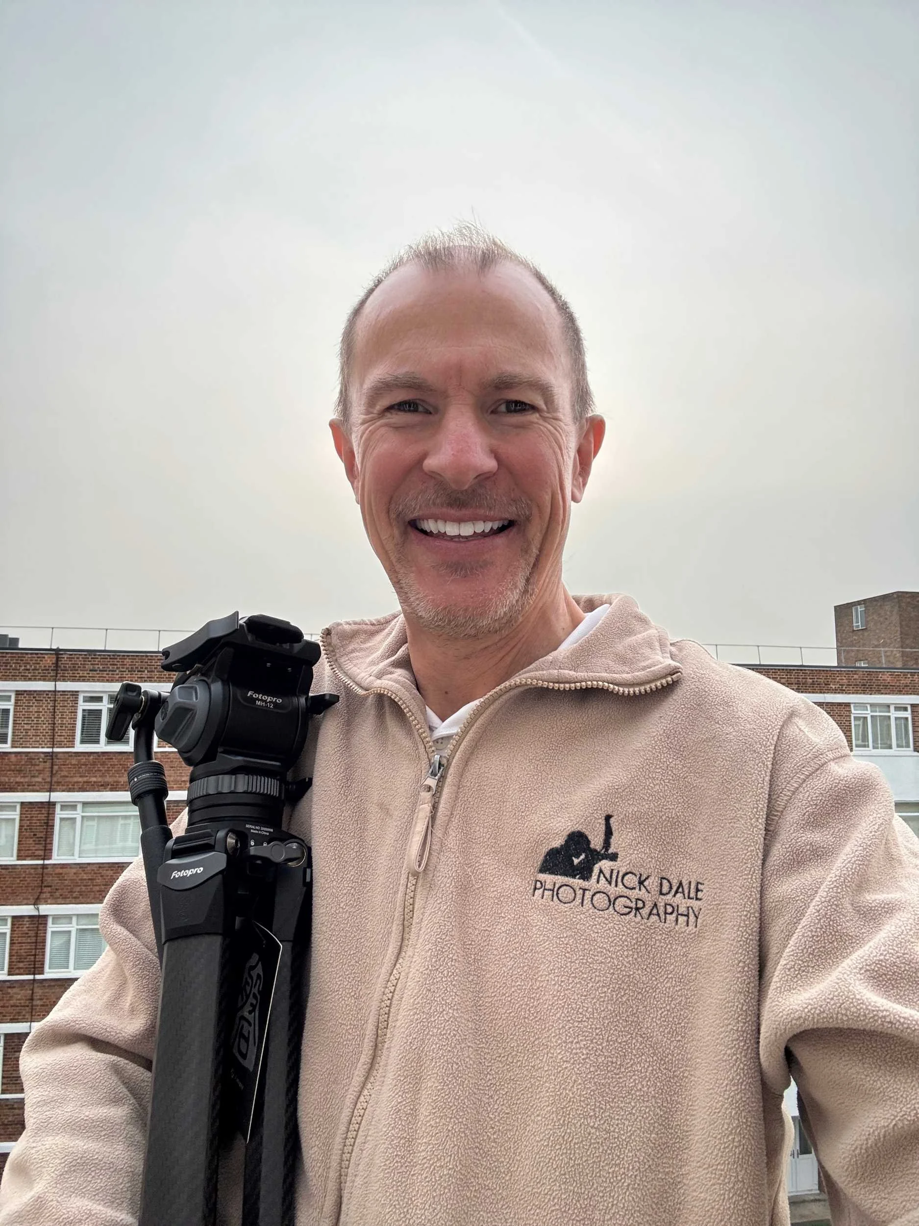 Nick Dale stands holding Fotopro O-9+MH-12 tripod