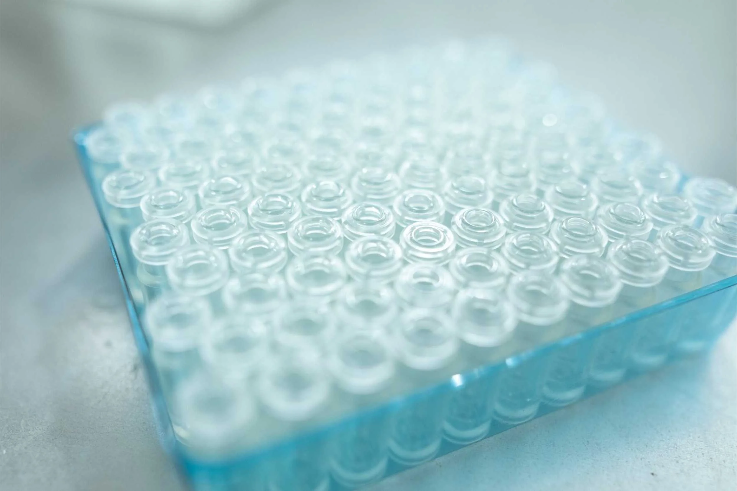 Tray of lab vials on white surface