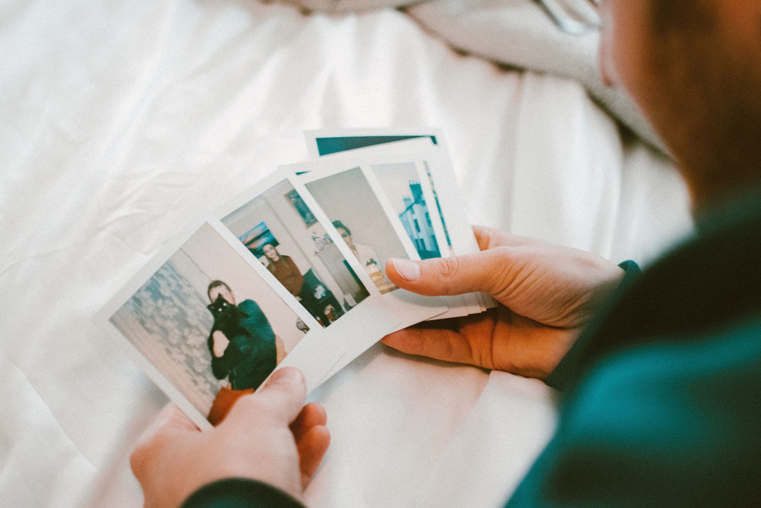 Someone holds portrait photos in hands
