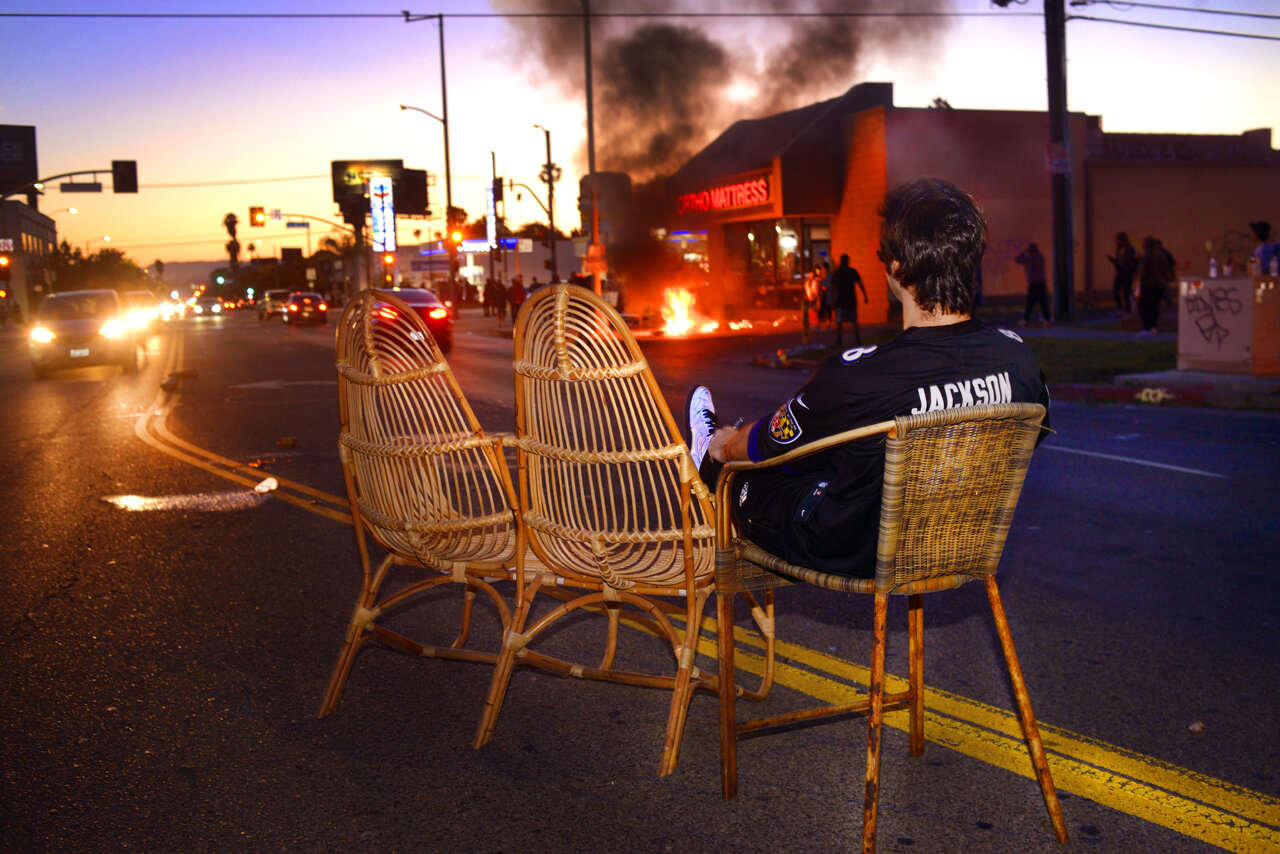  GEORGE FLOYD PROTESTS  Reclining on an chair set looted from a nearby boutique and left abandoned  in the middle of Beverly Boulevard, a young man watches riots unfold in his neighborhood. 