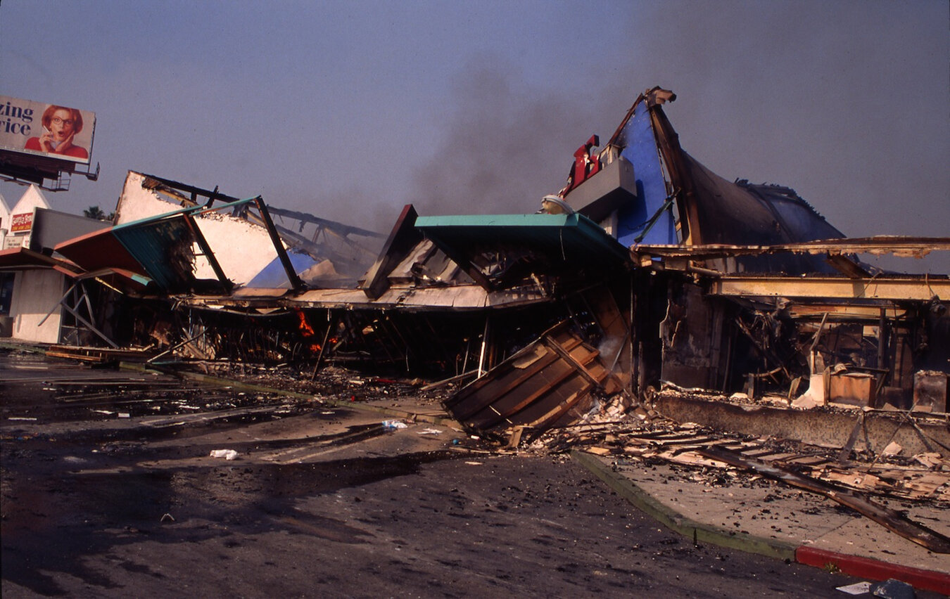  RODNEY KING RIOTS  A billboard appears to react to a destroyed mini mall in South Central Los Angeles where looting and vandalizing were the most concentrated, 1992 