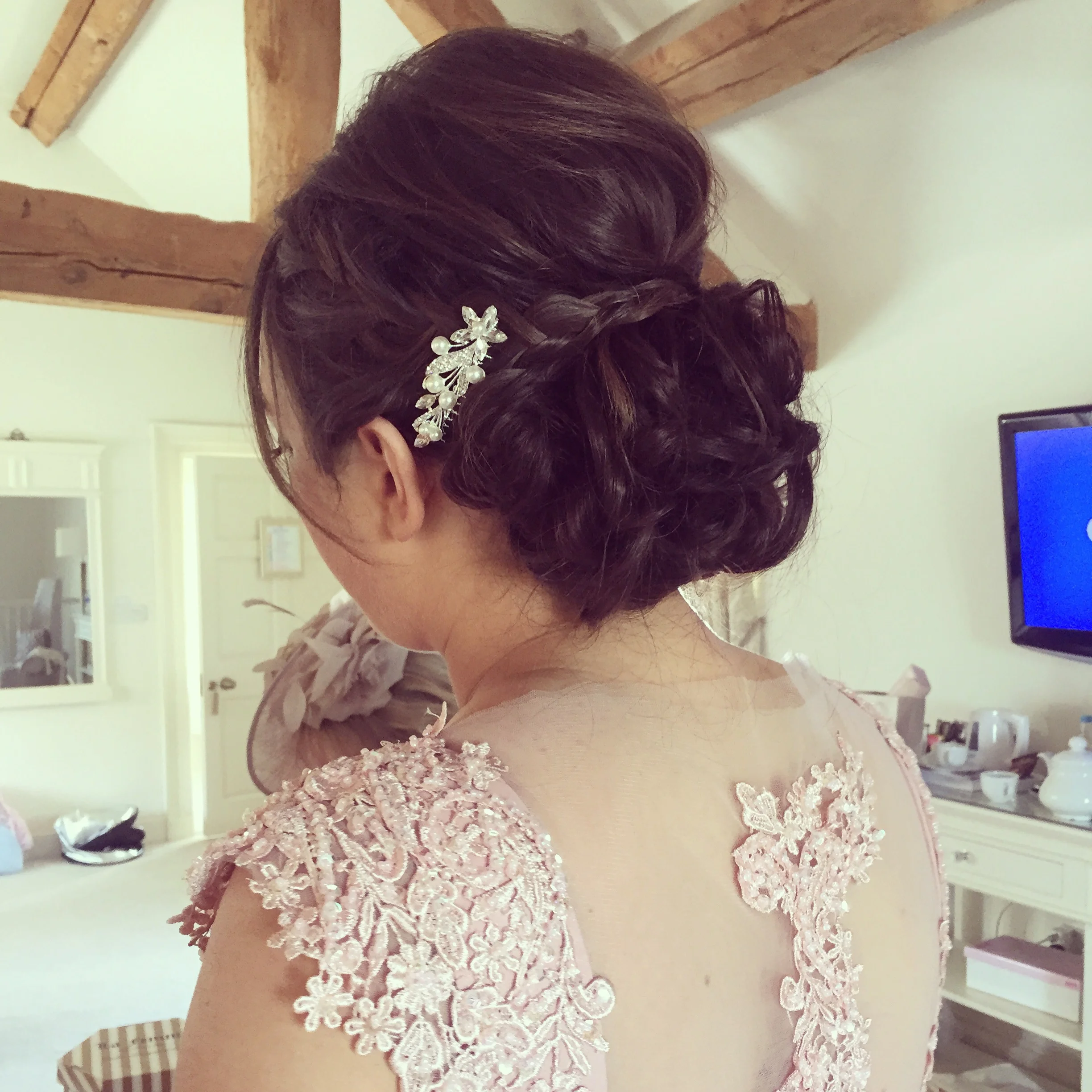The girls had a tousled low hair up with plaits that loosely wrapped around.