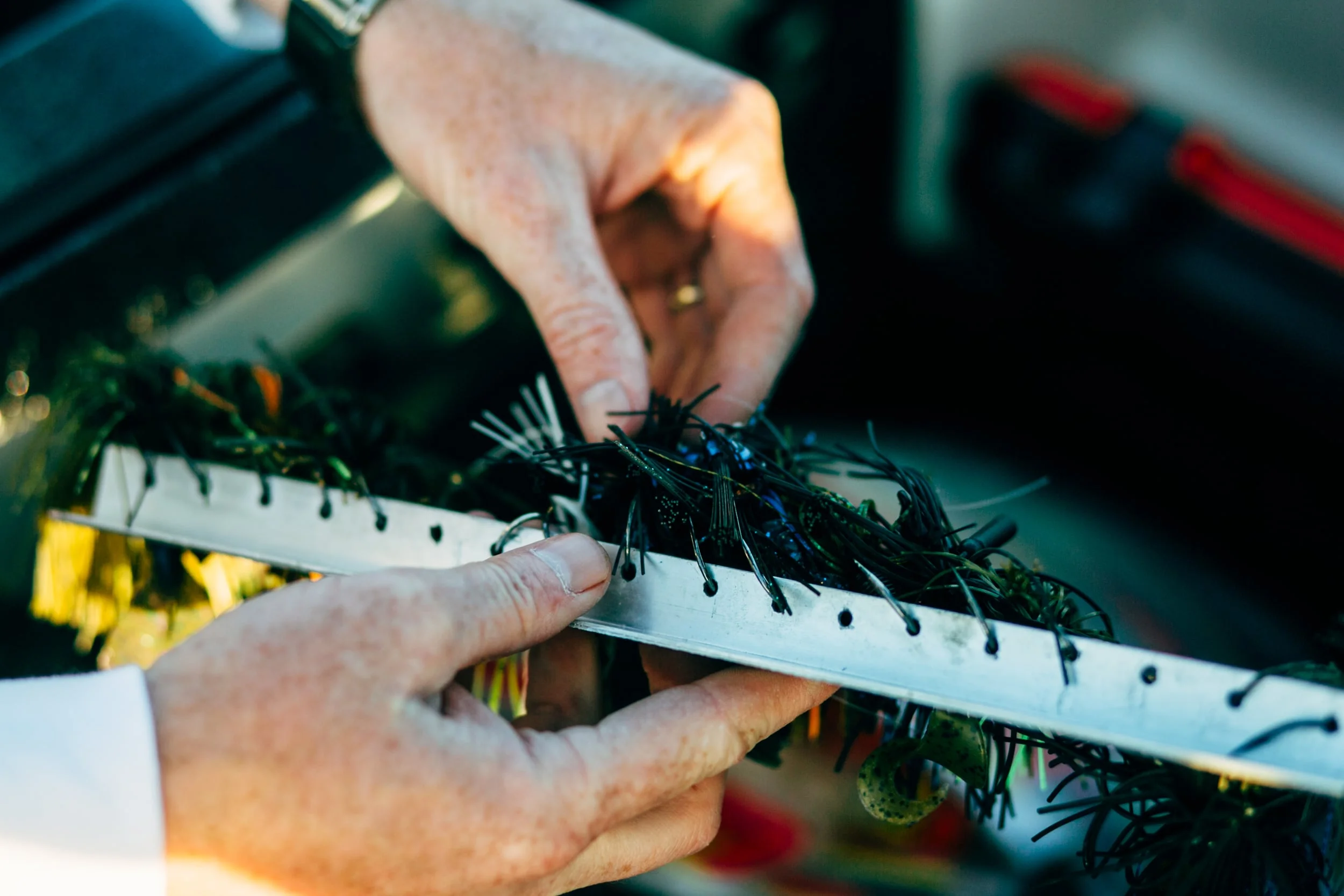 Gordon selects a bass jig from his bait rack. 