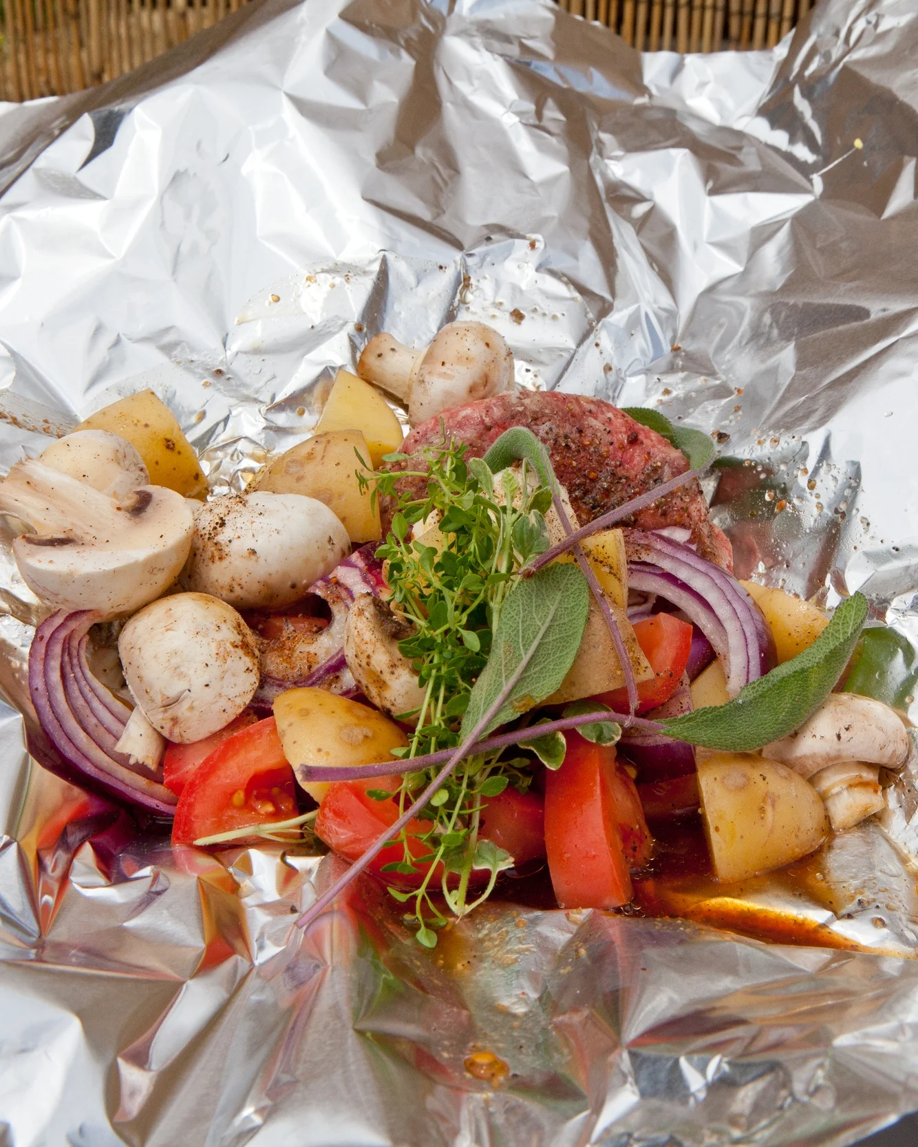 Preparing a hobo meal is quite simple: Place ingredients on aluminum foil then fold into a sealed packet and cook over hot coals. Photos by Matthew Martin