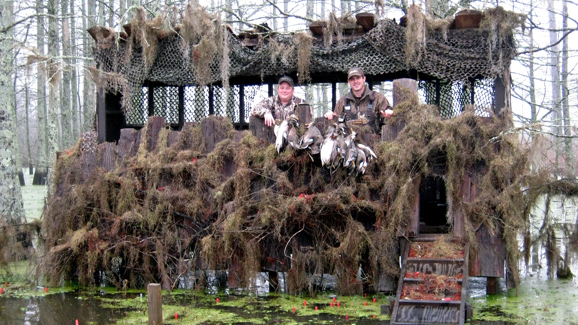 Tom Wingard and Paul Griffin show off their kill in one of several cypress slough blinds author John McClendon uses to entertain business guests.