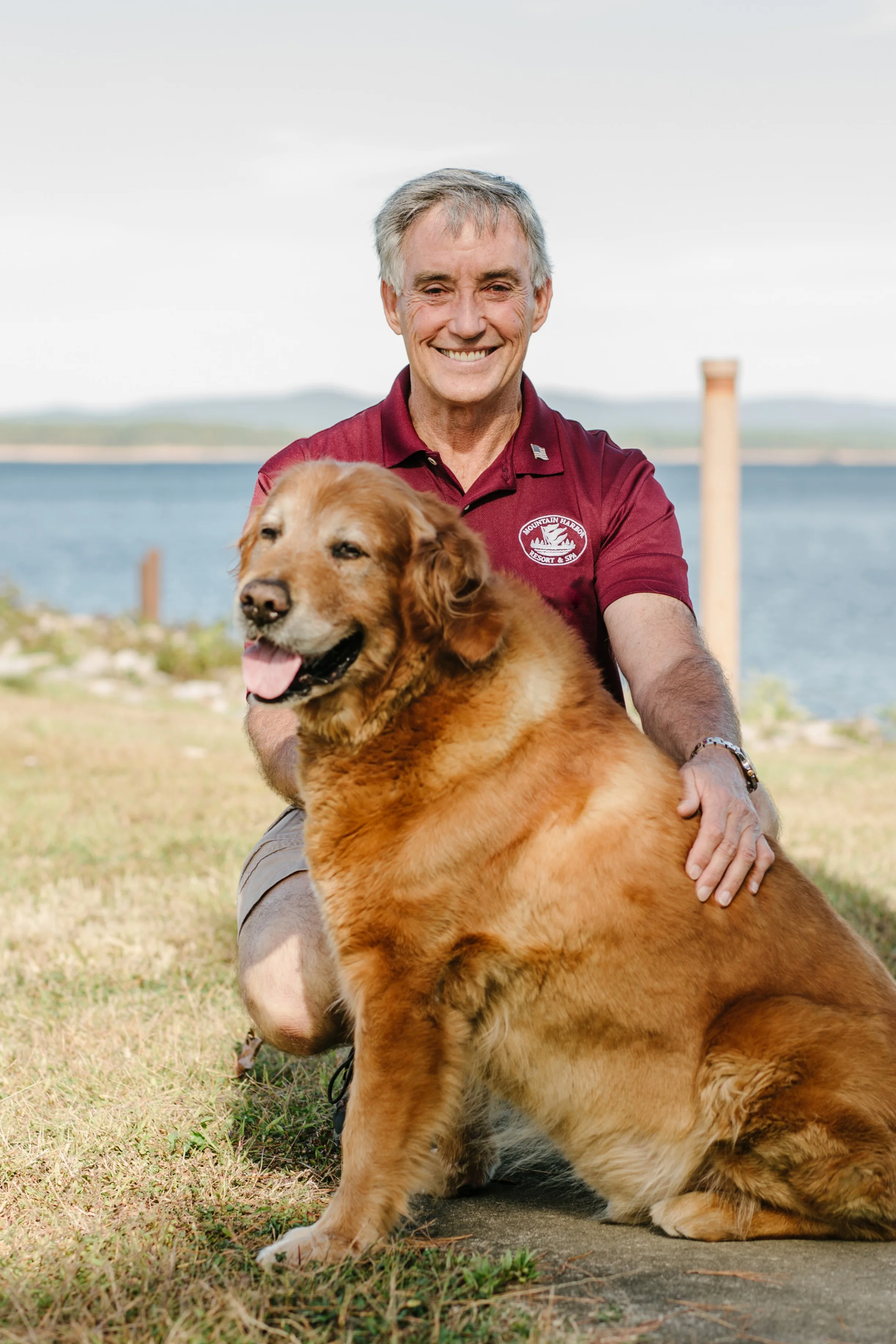 Bill Barnes enjoys walking out to the point overlooking Lake Ouachita at Mountain Harbor Resort with his dog, Harbor Dog.