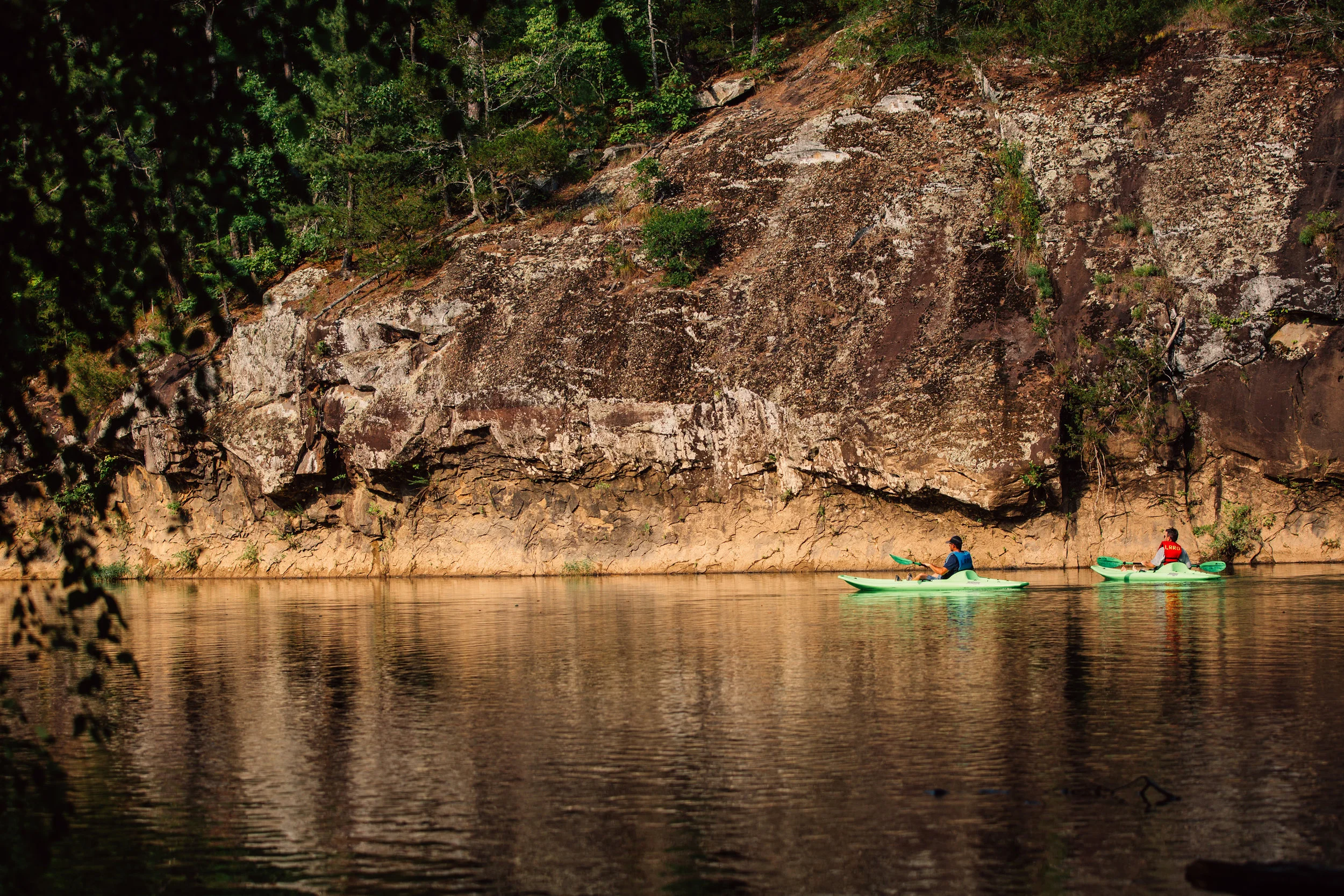 Two paddlers take in the serene beauty of the Little Red River.