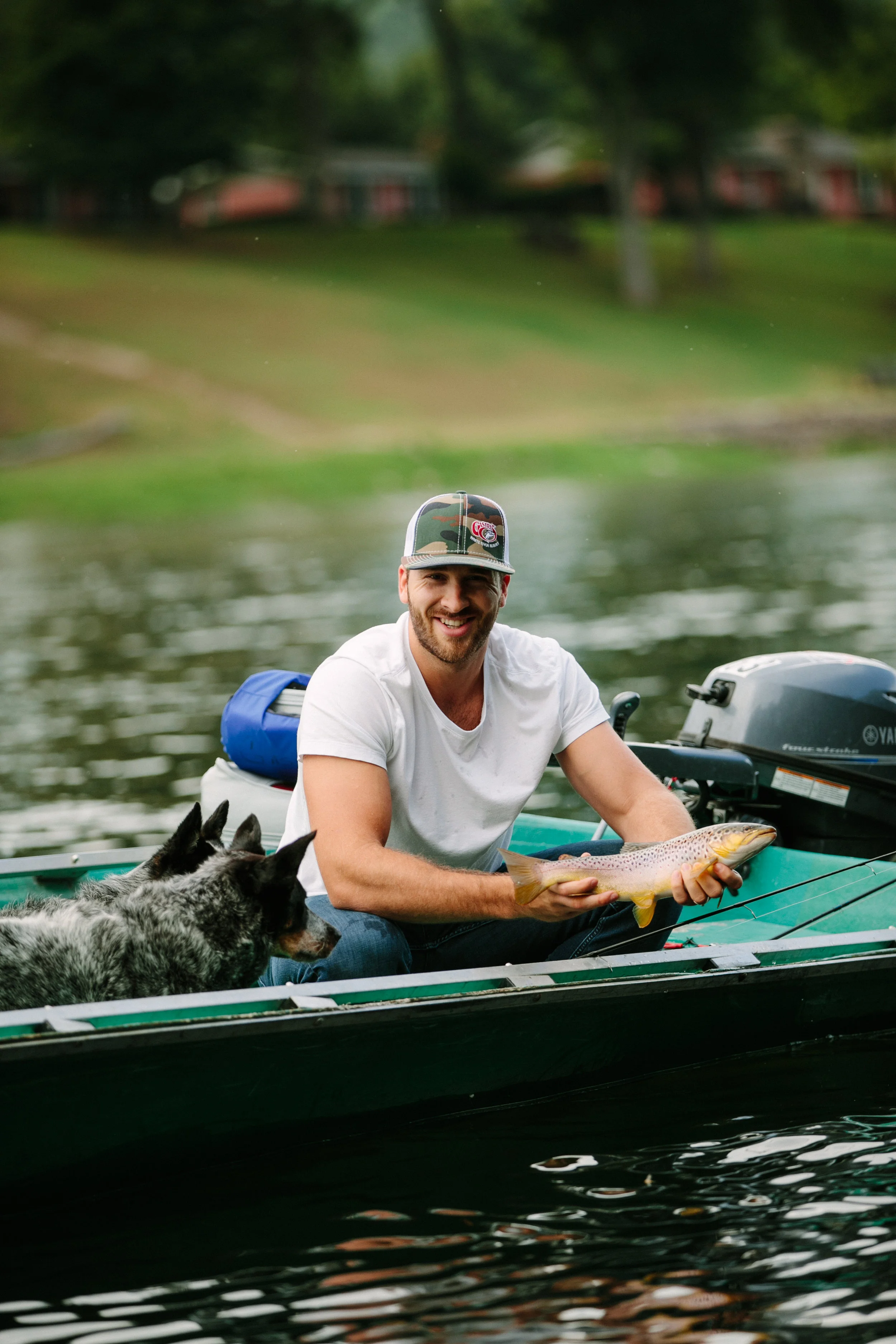 Clint holds a freshly-caught trout. 