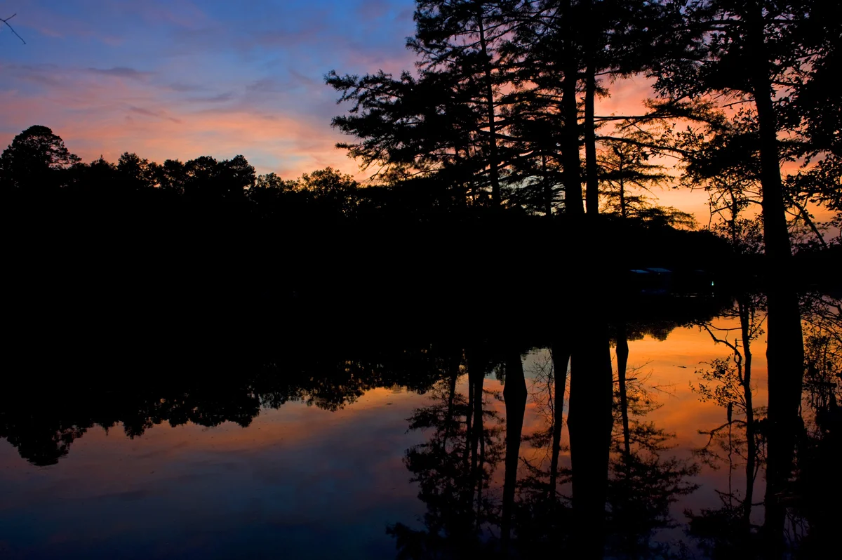 Sunset casts its splendor over the calm of Moro Bay. Once thriving with river traffic, the state park near El Dorado teems with various fish, wildlife and plant species.