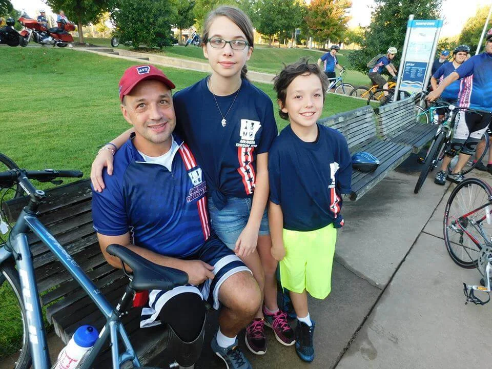 Navy veteran Jason Lentz of Fort Smith, with his kids Brianna and Zachary at the Arkansas Challenge bike ride in Little Rock, credits AFF with getting him “off the couch.” - Photo courtesy of: Arkansas Freedom Fund