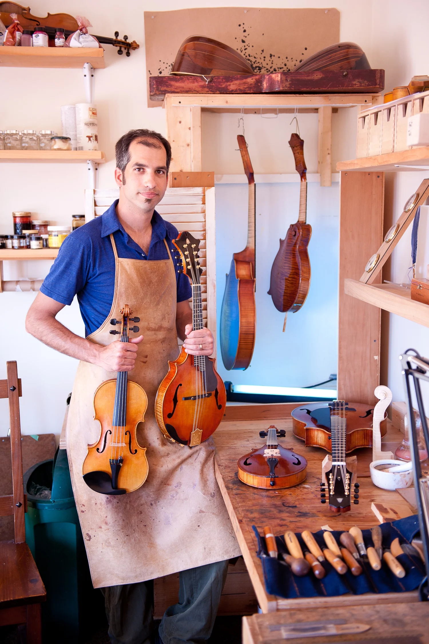 Model's Shown (L-R): Guarneri Model violin, Dué Mandolin, Dué mandola, F-5 Mandolin. Workbench: Dué Piccolo Mandolin, Dué Octave mandolin.