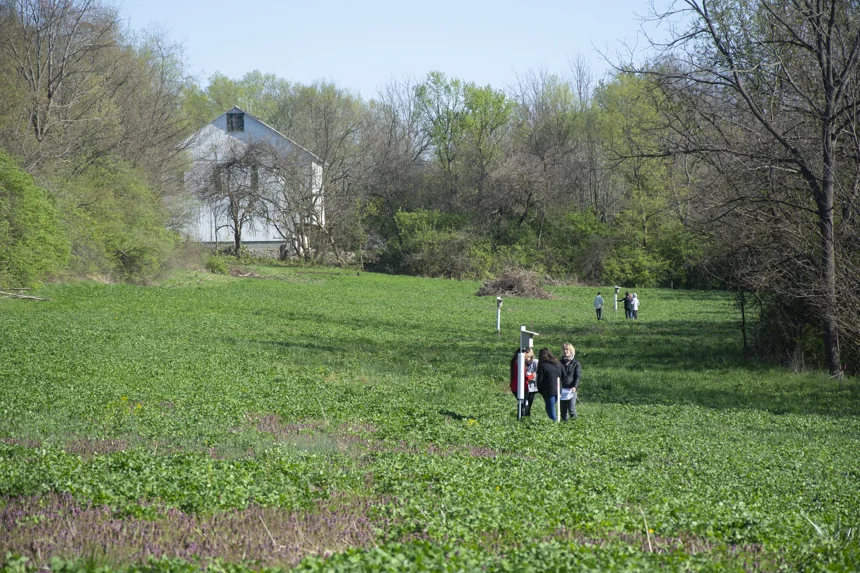 McKinney Middle School 7th graders and community volunteers check for activity at Agraria’s bluebird boxes.