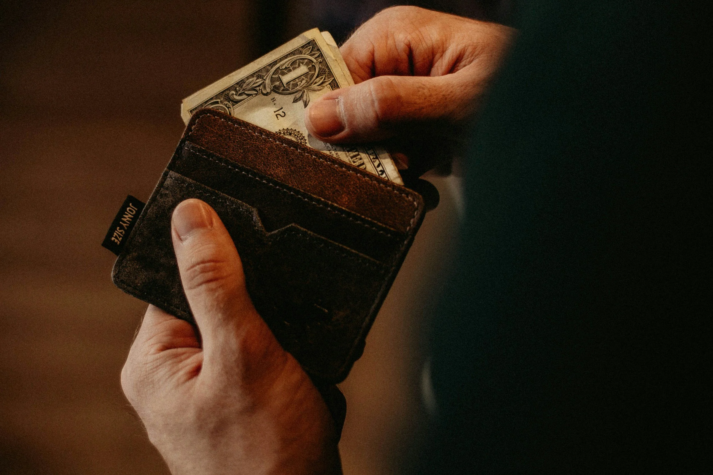 A wallet with money showing in Make a Monthly donation image